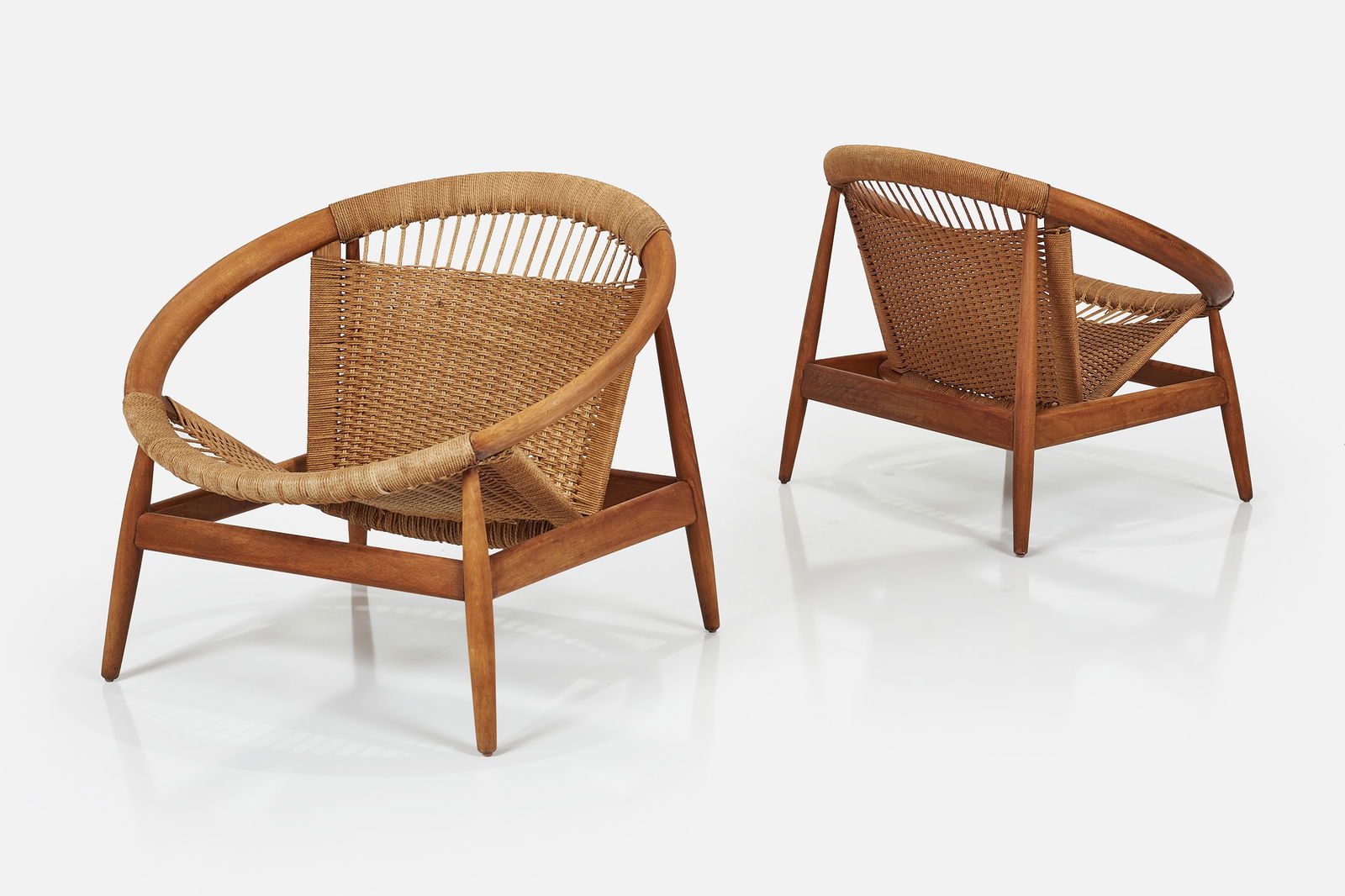 Illum Wikkelso, 'Ringstol' Lounge Chairs (2): ILLUM WIKKELSOPair of 'Ringstol' lounge chairs, ca. 1965Teak, cotton cord. Manufactured by Niels Eilersen, Denmark. Each: 26.75" H x 31.5" W x 28" DSeat height: 14"