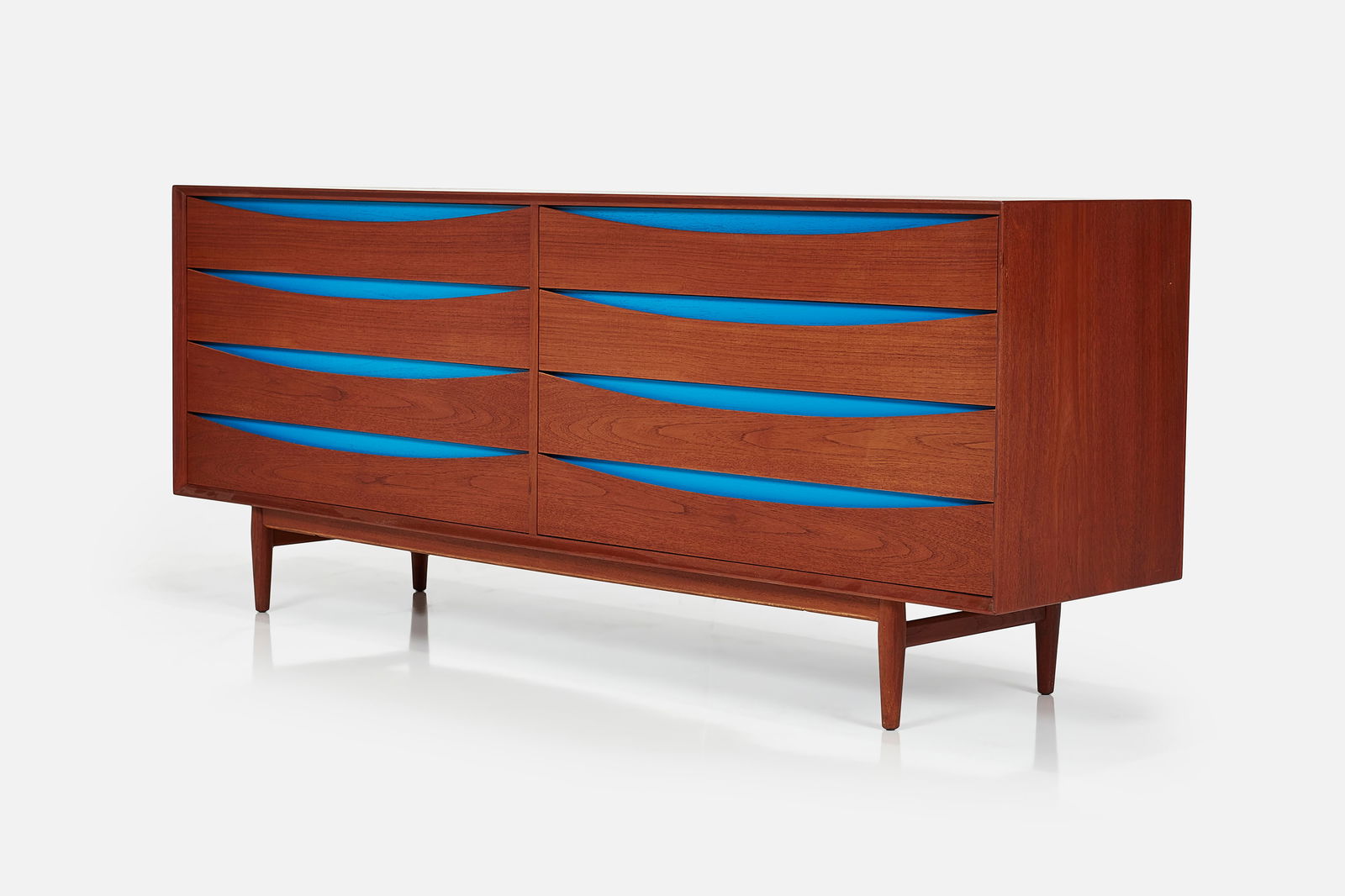 Arne Vodder, 'Triennale' Dresser: ARNE VODDER Eight-drawer 'Triennale' dresser, 1960s Teak, lacquered wood. Produced by Sibast, Denmark. Retains original manufacturer's decal inside. 32" H x 77.5" W x