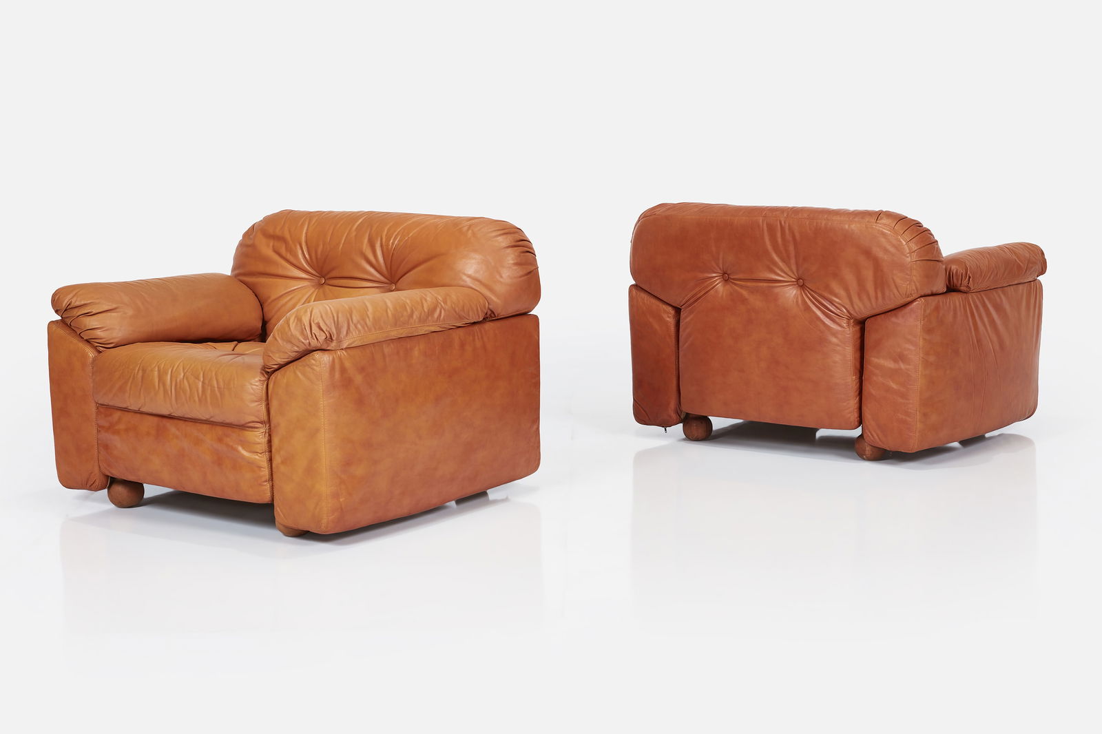 Sormani, Lounge Chairs (2): SORMANI Pair of lounge chairs, 1970s Leather, walnut, aluminum. Manufactured by Sormani, Italy. One leg with manufacturer's mark. Each: 27.5" H x 38" W x 31.5" D Seat