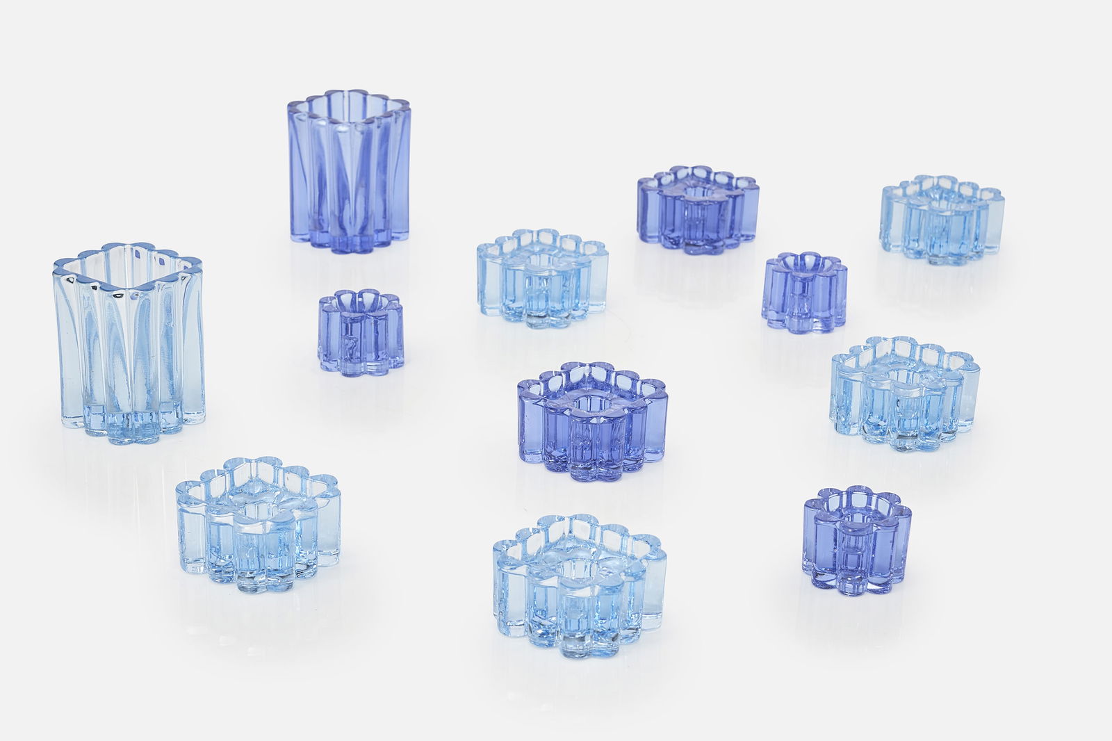 Christel Holmgren-Exner, 'Arcade' Table Accessories (12): CHRISTEL HOLMGREN-EXNERSet of 12 'Arcade' table accessories, ca. 1968Colored cast glass. Manufactured by Kastrup-Holmegaard Glasvaerk, Denmark.Each square candlestick cast with "MADE