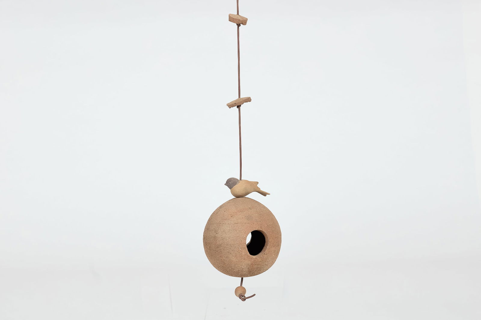 Stan Bitters, Birdhouse: STAN BITTERSBirdhouseUnglazed stoneware, glazed earthenware, plastic cording. Studio-made, Fresno, CA 36" Drop x 6.5" Diameter