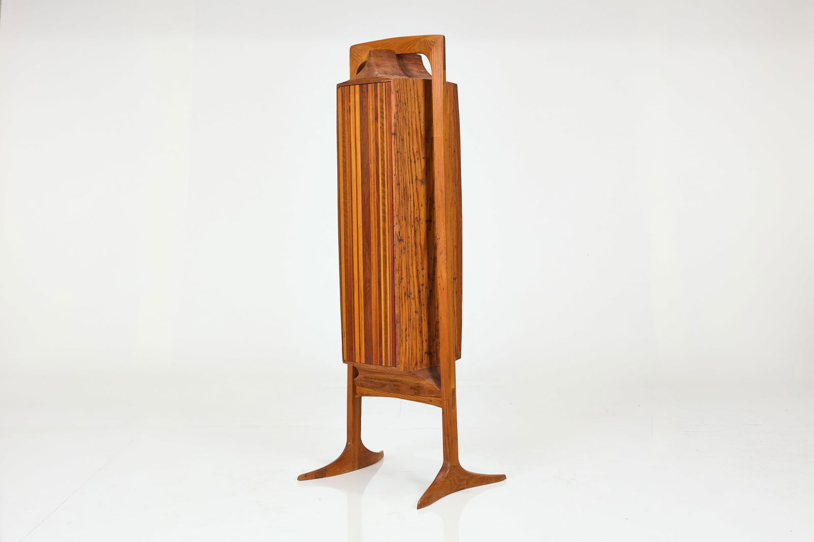 Jack Rogers Hopkins, Music Cabinet: JACK ROGERS HOPKINSMusic cabinet, 1960sVarious woods. Studio-made in California.Branded signature on the inside of door. 68" H x 19" W x 15" D Exhibited: 'Jack Rogers Hopkins: California Design Maveri