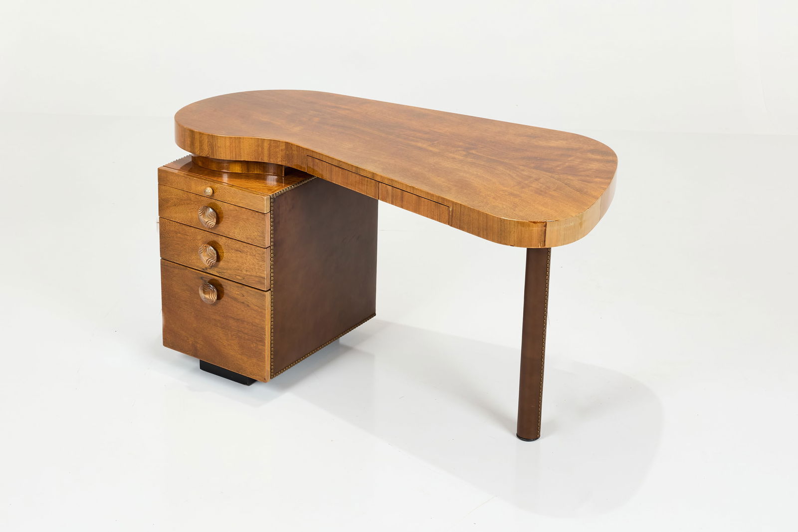 Gilbert Rohde, 'Paladao Group' Desk: GILBERT ROHDE'Paladao Group' desk, model no. 4106, ca. 1940Paldao, acacia burl, imitation leather, brass. Manufactured by Herman Miller, USA.Interior of drawer with manufacturer's label.&n