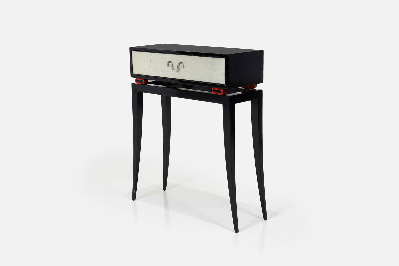 Tommi Parzinger, Petite Console Table: TOMMI PARZINGERPetite console table, ca. 1949Lacquered wood, silver gilt, nickel-plated brass. Produced by Charak Modern, USA.Interior of the drawer with producer and retailer labels. 36"