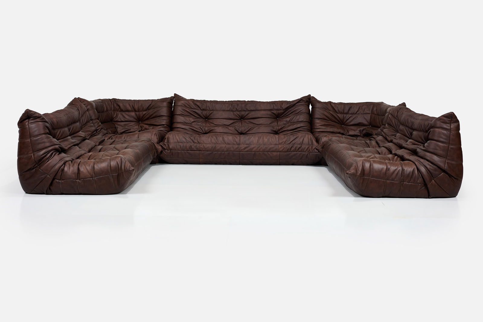 Michel Ducaroy, 'Togo' Sectional Sofa (6): MICHEL DUCAROYFive-part sectional sofa, designed 1973Leather, foam. Manufactured by Ligne Roset, France. One three-seater with the manufacturer's fabric seam tag and branded decking