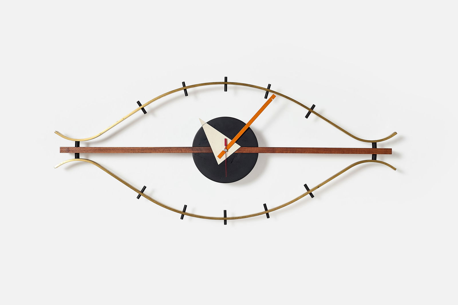 George Nelson + Associates, 'Eye' Wall Clock: GEORGE NELSON + ASSOCIATES'Eye' wall clock, model no. 2238, ca. 1957Walnut, brass, enameled metal. Manufactured by Howard Miller Clock Company, USA. 15.25" H x 29.75" W