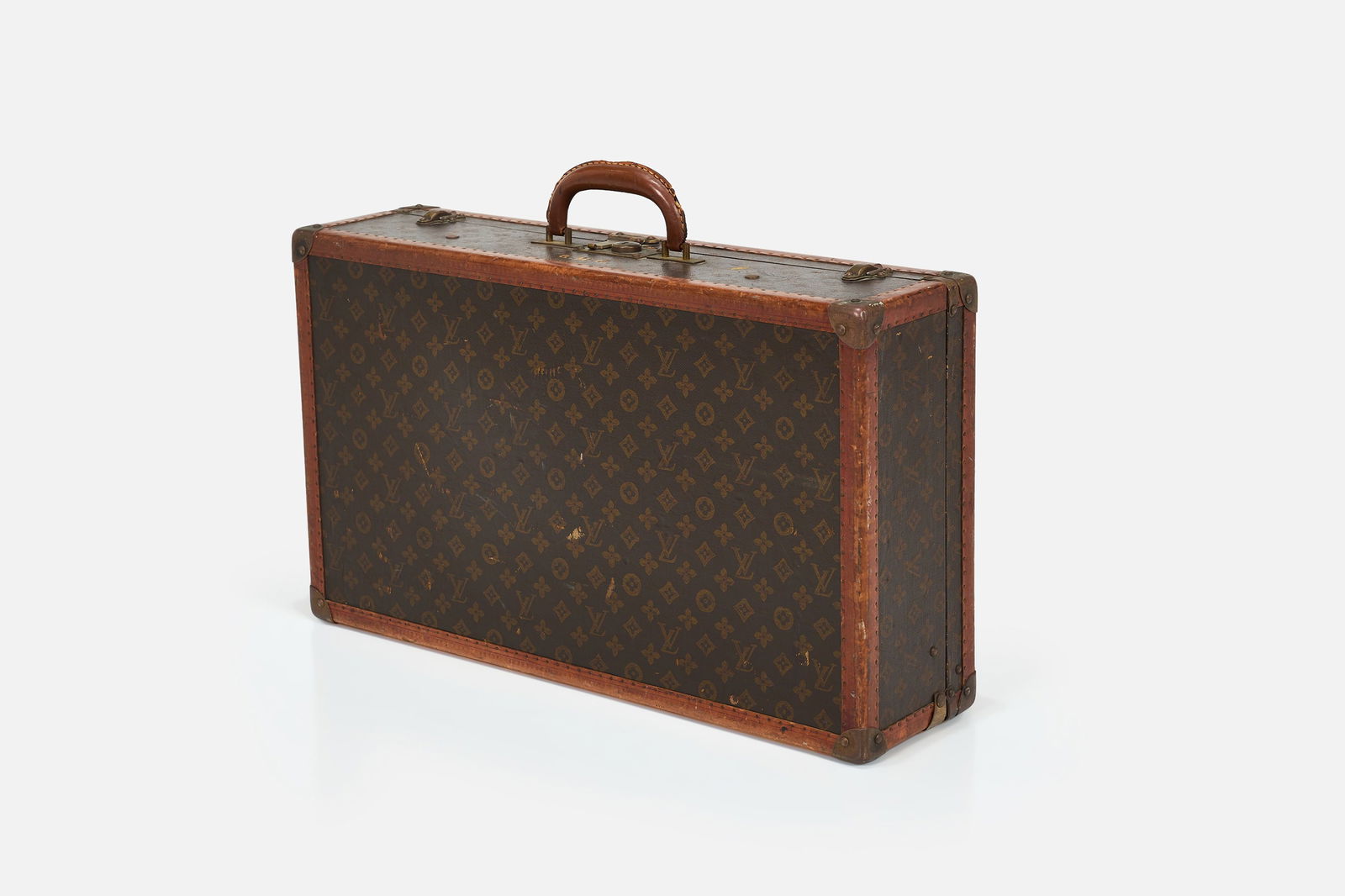 Louis Vuitton, Suitcase: LOUIS VUITTONSuitcase, 1925-1932Monogrammed canvas, lozine leather, leather, brass. Produced by Louis Vuitton, France. Various producer's marks throughout. 15.5" H x 26&