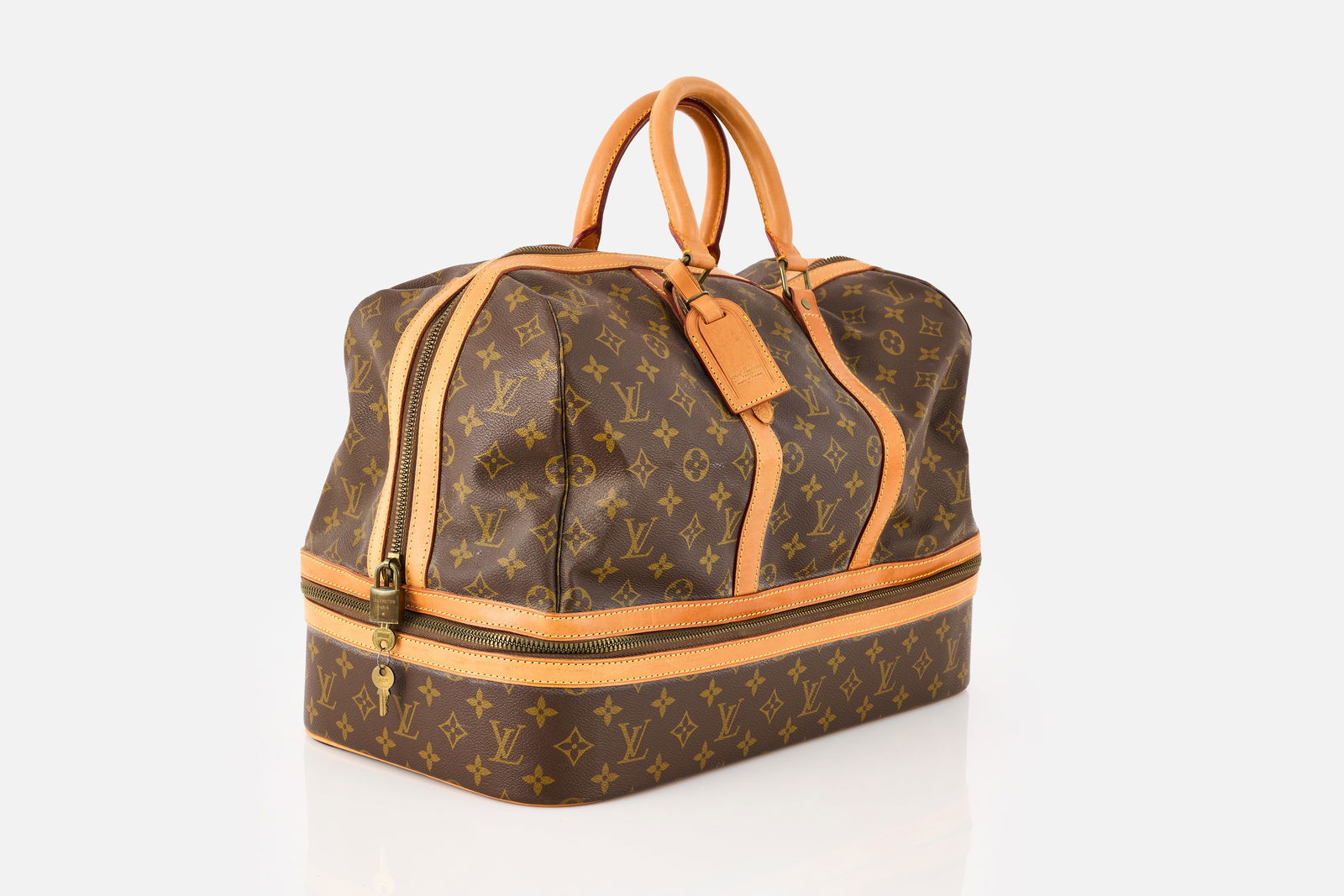 Louis Vuitton, 'Alize 24H' Overnight Bag: LOUIS VUITTON'Alize 24H' overnight bag, ca. 1990Canvas, leather, fabric. Produced by Louis Vuitton, France. Various producer's marks throughout. 12" H x 17" W x 10&qu