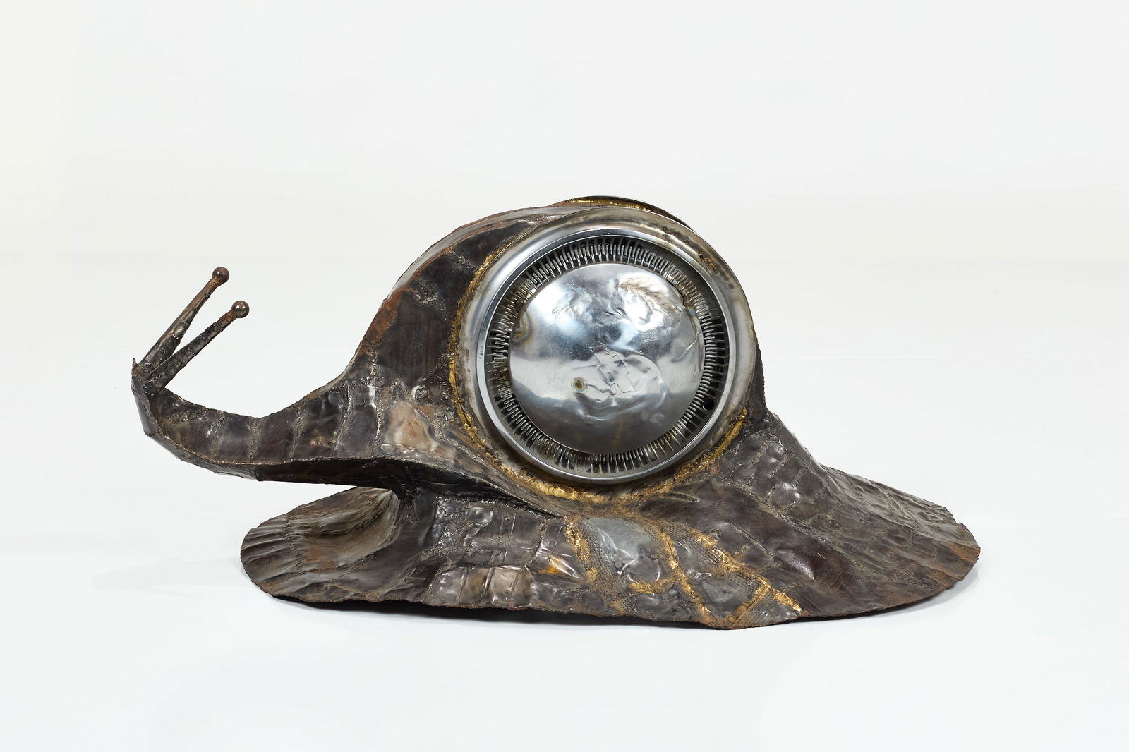 Studio Craft, 'Hubcap Snail' Sculpture: STUDIO CRAFT'Hubcap Snail' sculpture, 1970sTorch-welded metal, found hubcaps. 21" H x 29" W x 45" D