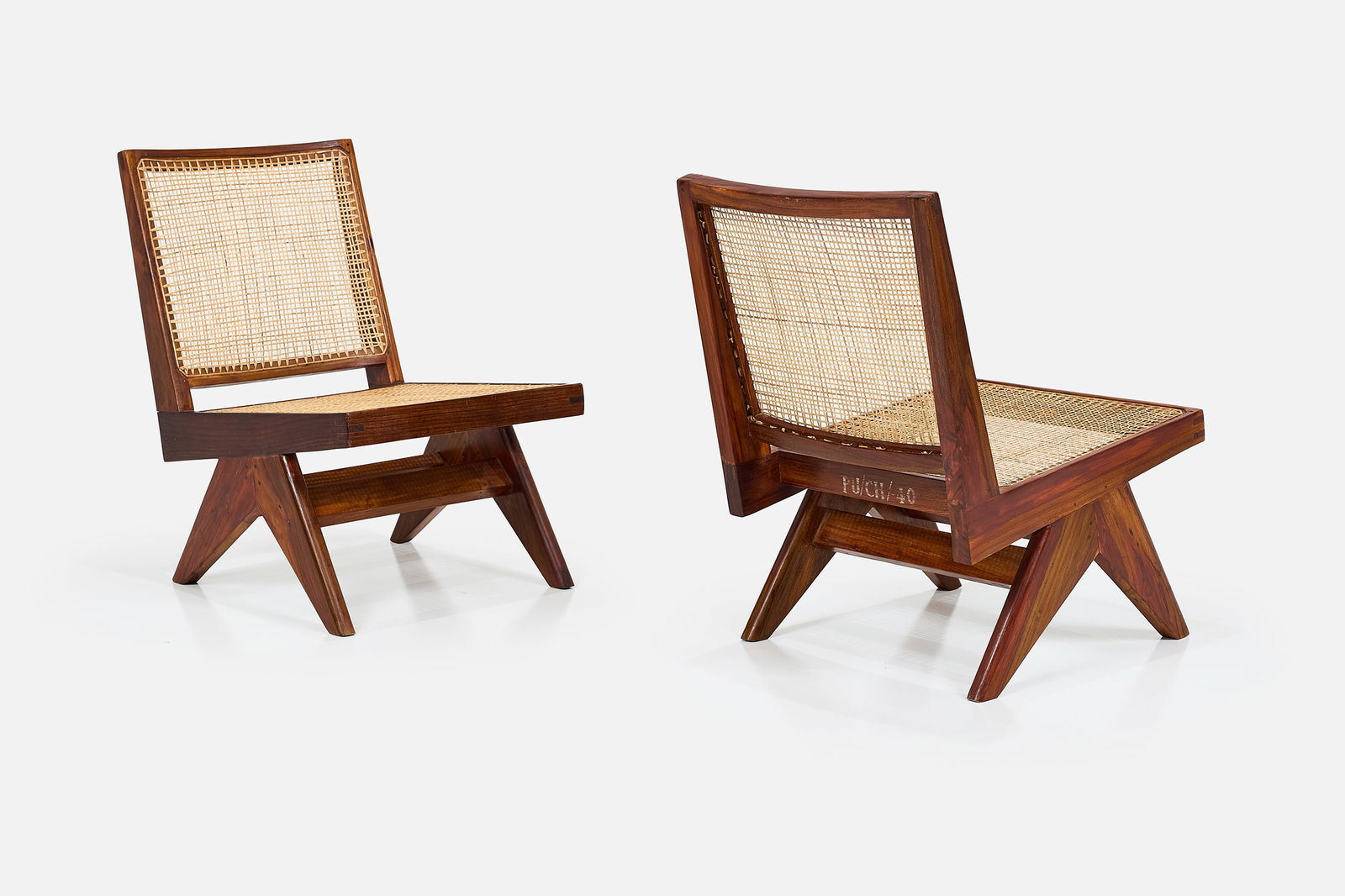 Pierre Jeanneret, Armless Easy Chairs (2): PIERRE JEANNERET Pair of armless easy chairs, from Chandigarh, ca. 1960 Teak, cane. Produced in France / India for Punjab University, Chandigarh, India. Stenciled marks to each example. Each: