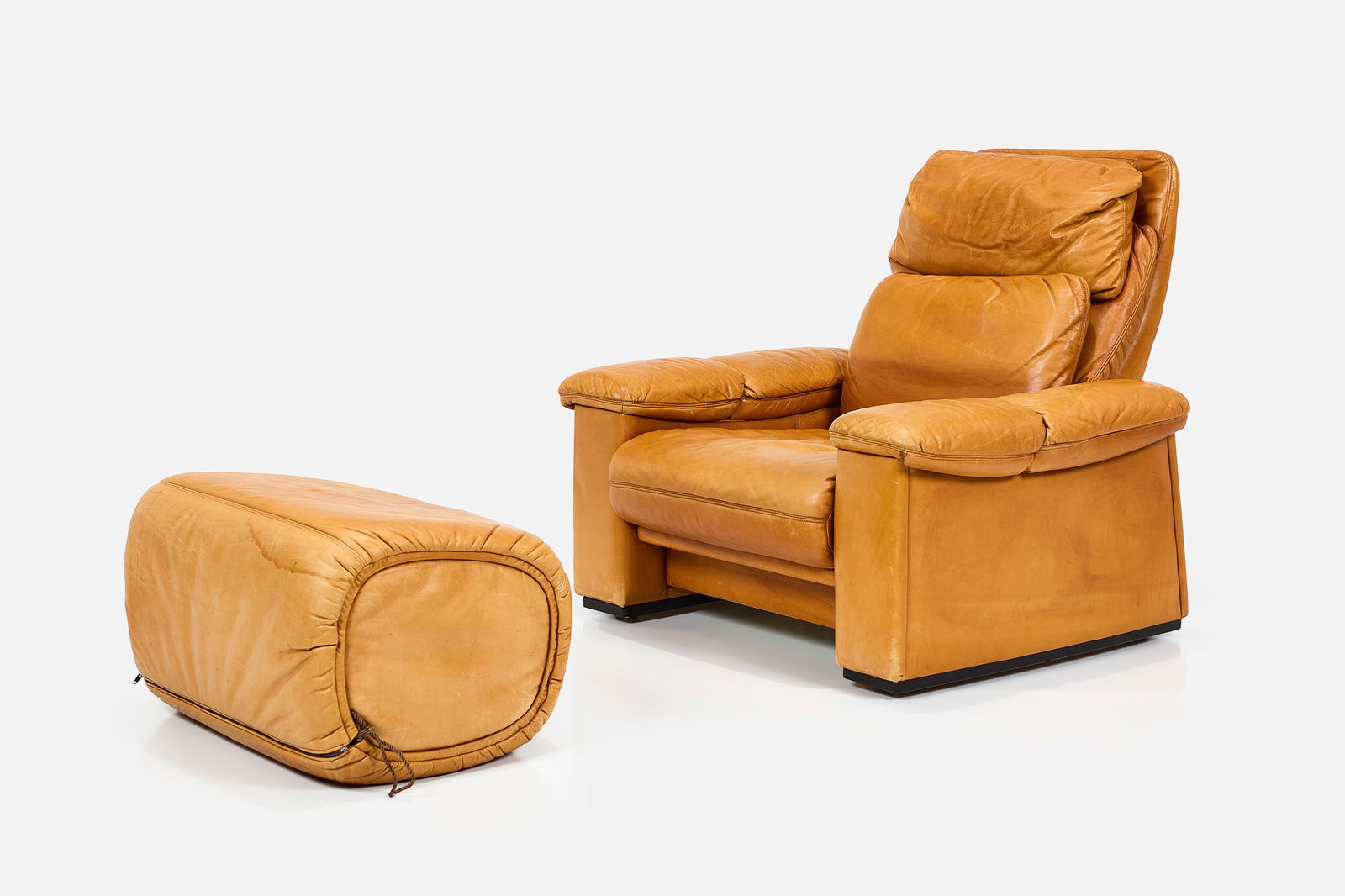 Modern, Reclining Lounge Chair + Ottoman (2): MODERN Lounge chair and ottoman, 1970s Leather, plastic, wood. The arm flips up to reveal a remote control that controls the reclining motion of the chair. Chair: 36" H x