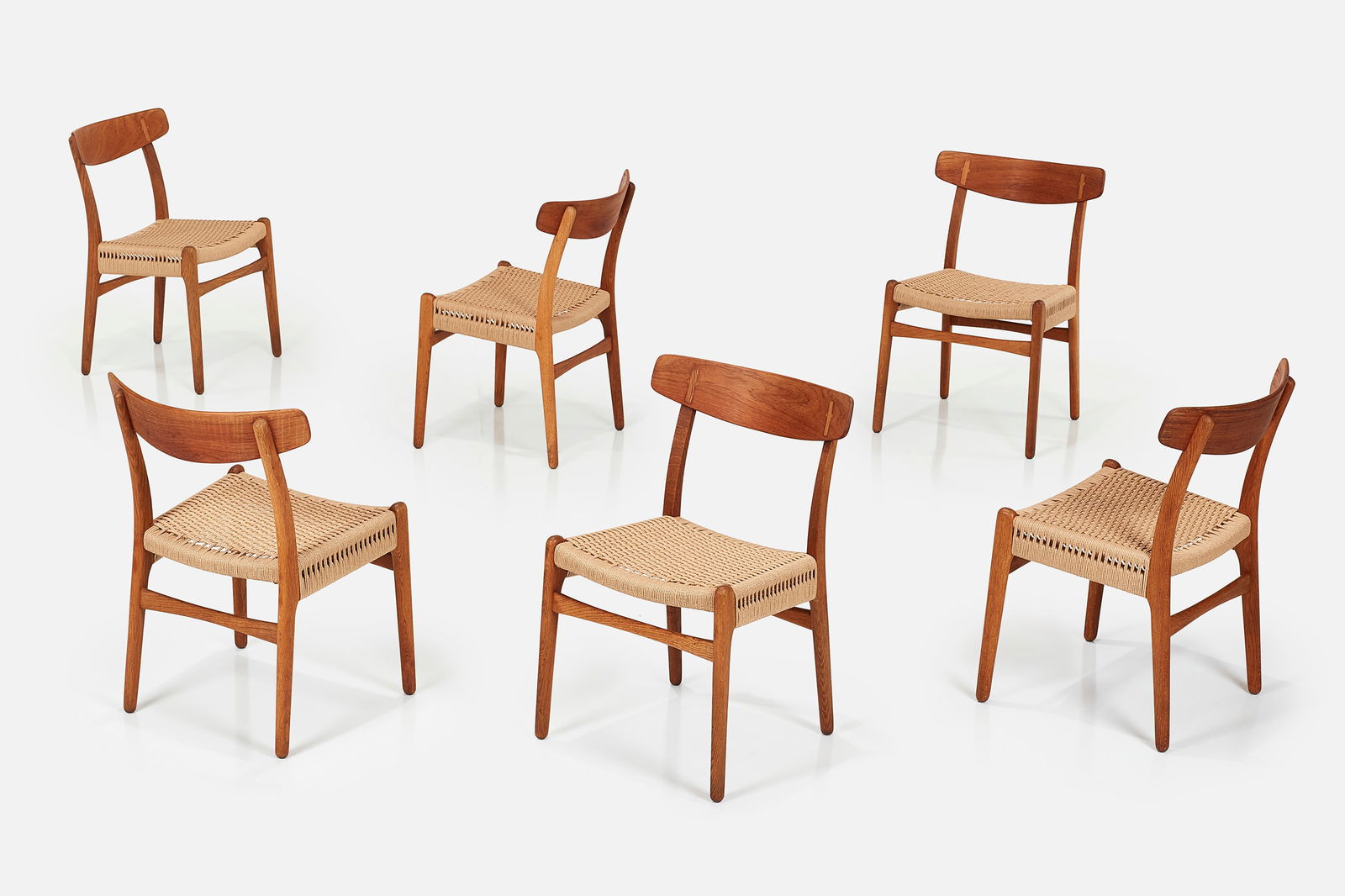 Hans J. Wegner, Dining Chairs (6): HANS J. WEGNER Set of six dining chairs, model no. CH-23, 1960s Oak, cane. Manufactured by Carl Hansen & Sons, Denmark. Each branded with manufacturer's branded mark to the
