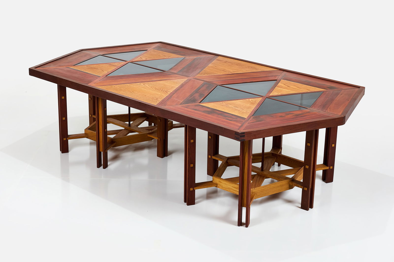 Studio Craft, Large Dining Table: STUDIO CRAFT Large table, 1970s Various hardwoods, smoked glass. Studio-made, USA. 32" H x 120" W x 66" W