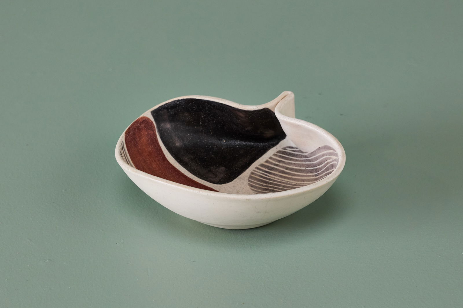 Mado Jolain, Pinched Bowl: MADO JOLAIN Pinched bowl, 1950s Glazed earthenware. Produced in France. Signed "MJ" to the underside. 3" H x 8.75" W x 7.5" D