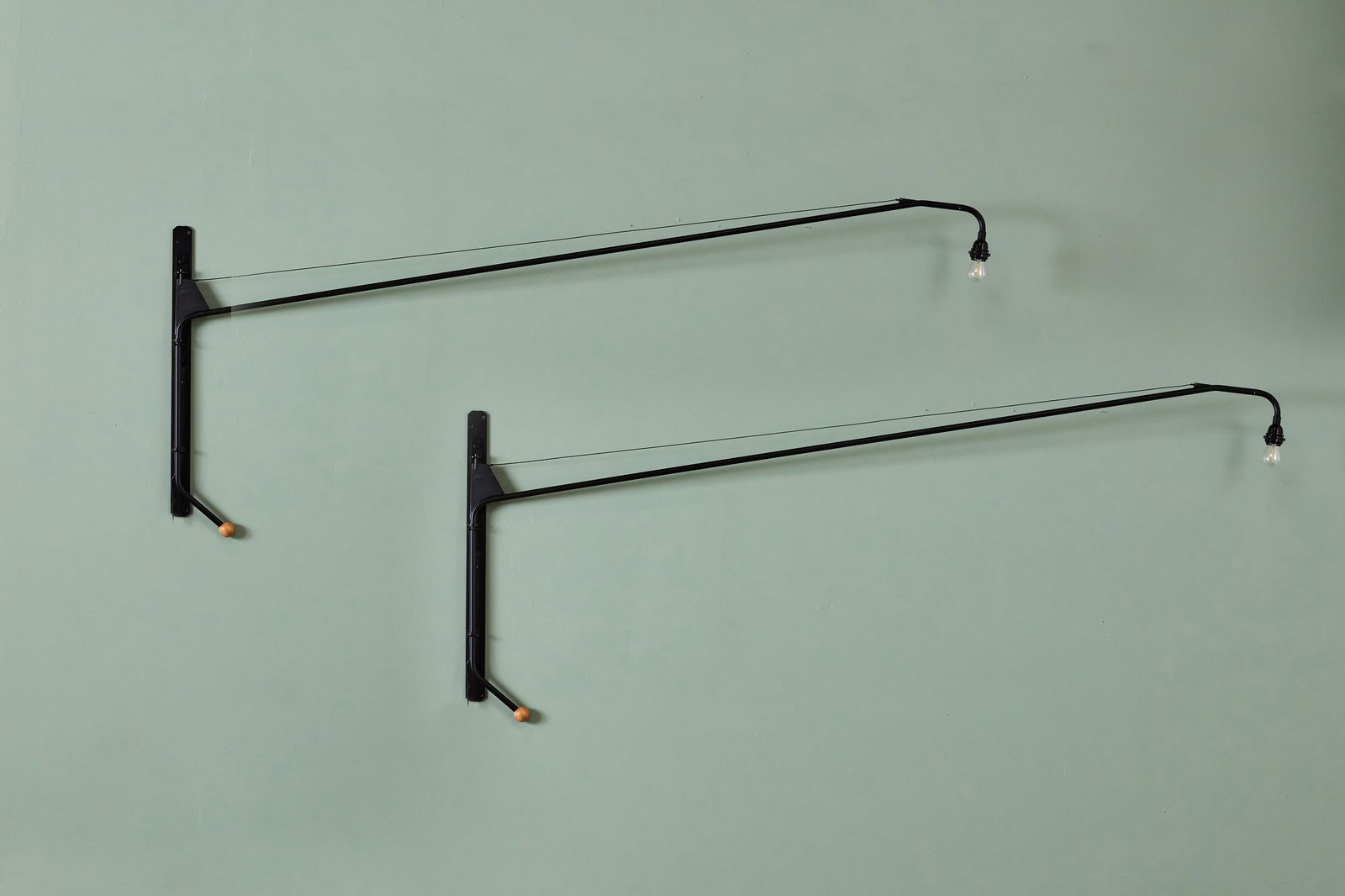 Jean Prouve + Charlotte Perriand, 'Potence' Lamps (2): JEAN PROUVE + CHARLOTTE PERRIAND Pair of 'Potence' wall lights, 1950 / 21st century Powder-coated steel, oak. Manufactured by Stilnovo, Italy. 29.75" H × 2" W ×
