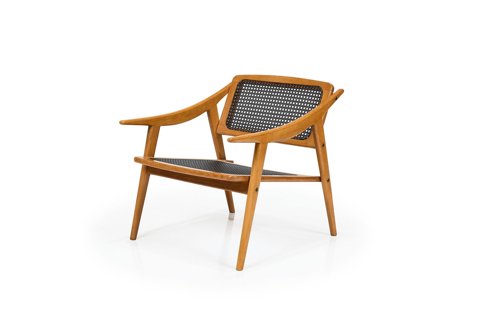 Michel Ducaroy, Lounge Chair: MICHEL DUCAROY Lounge chair, 1954 Oak, plastic caning, brass. Produced by SNA Roset, France. 25" H x 23.75" W x 27.75" D Seat height: 14" 