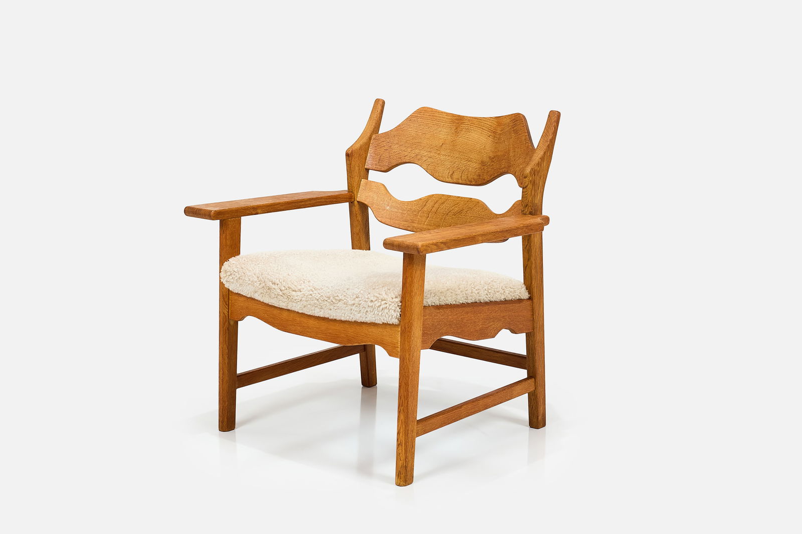 Henning Kjaernulf, 'Razor' Lounge Chair: HENNING KJAERNULF 'Razor' lounge chair, 1960s Oak, faux shearling. Produced by EG Kvalitetsmobel, Denmark. 30.25" H x 28.75" W x 26" D Seat height: 16"