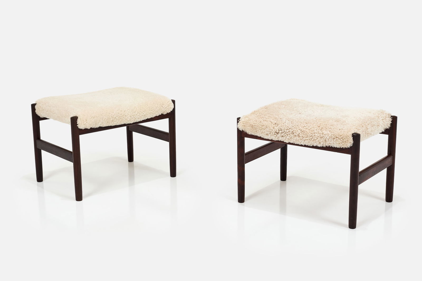 Hugo Frandsen, Stools (2): HUGO FRANDSENPair of stools, 1960sRosewood, faux shearling. Produced by Spottrup Mobler, USA.Underside stamped with manufacturer's mark. Each: 15" H x 20.75" W x 16.25" D
