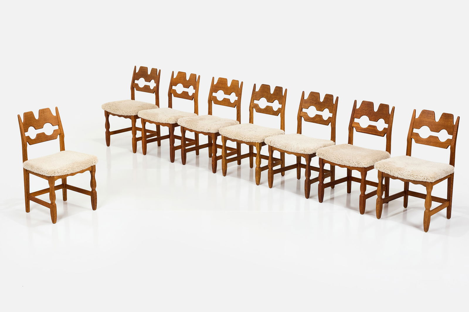 Henning Kjaernulf, 'Razor' Dining Chairs (8): HENNING KJEARNULF Set of eight 'Razor' dining chairs, 1960s Oak, faux shearling. Produced by EG Kvalitetsmobel, Denmark. Each: 33.5" H x 20" W x 19" D Seat height: