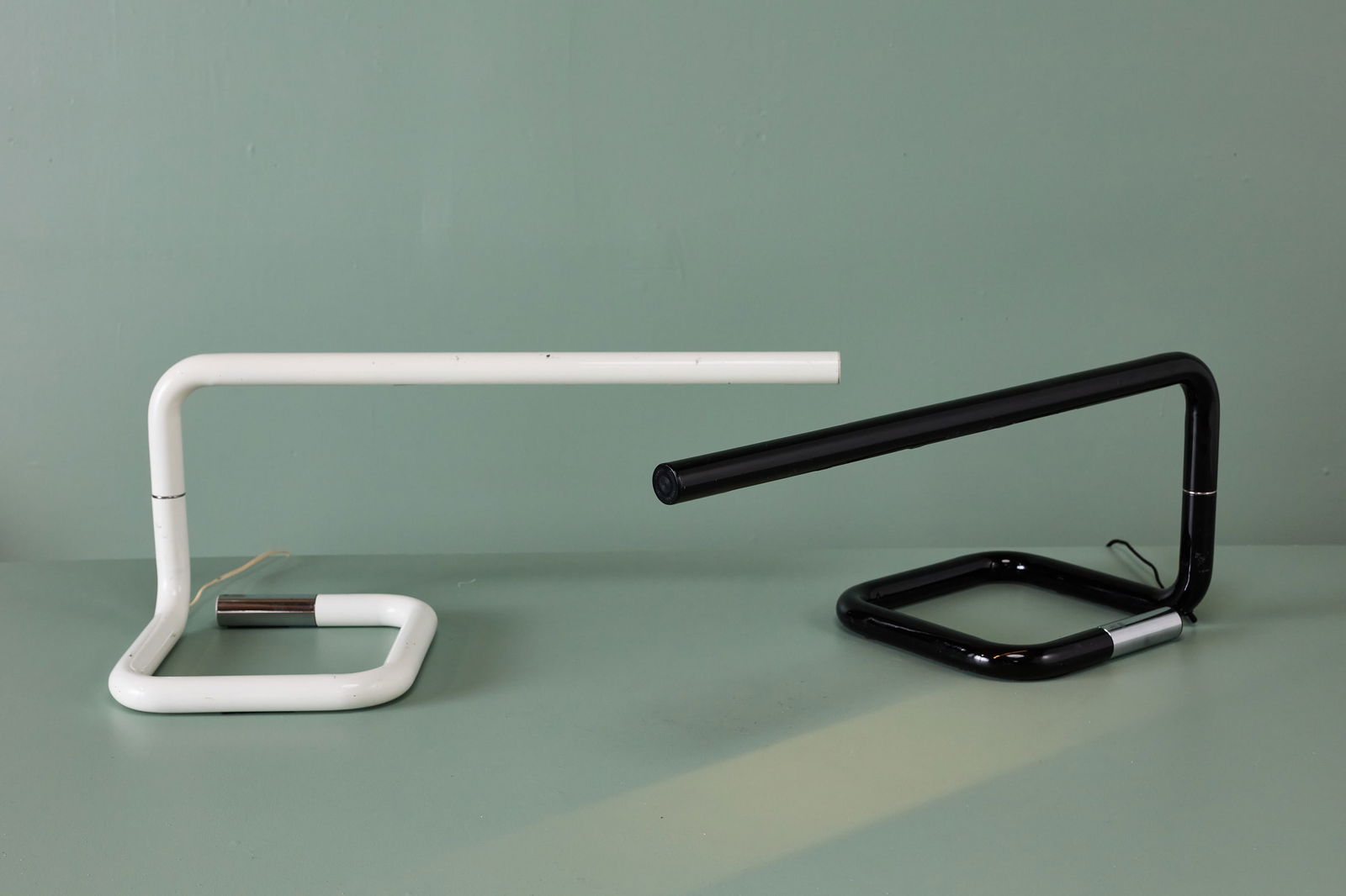 Lucio Roncalli, 'Fuga' Table Lamps (2): LUCIO RONCALIPair of 'Fuga' table lamps, 1970sLacquered tubular steel, chrome-plated steel. Manufactured by Luci, Italy.Manufacturer's decal and ends molded with manufacturer's informa