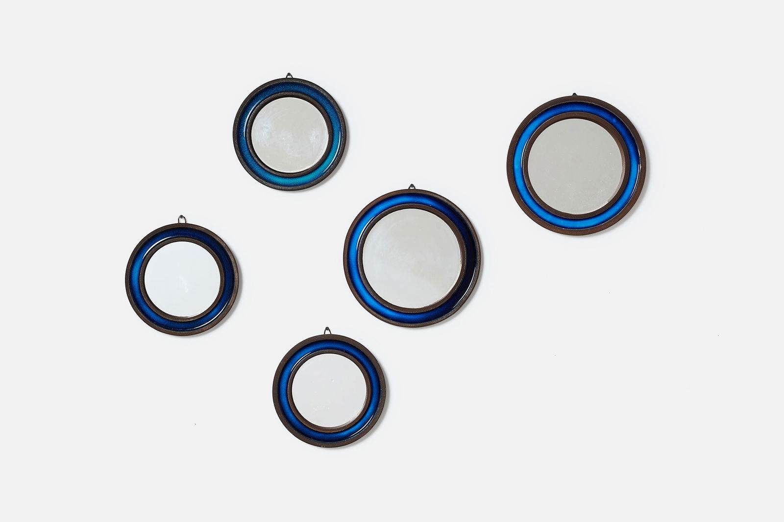 Erik Reiff, Wall Mirrors (6): ERIK REIFFSet of six mirrors, 1952Glazed earthenware, mirrored glass. Produced by Knabstrup, Denmark.One with manufacturer's label to the back. Large: 12.5" DiameterSmall: 10" Dia