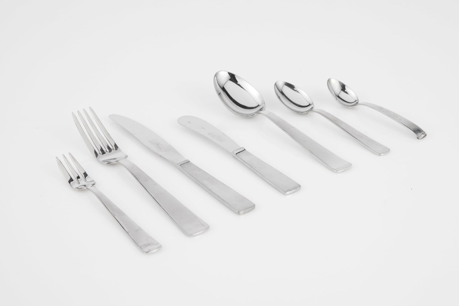 Gio Ponti, 'Milano' Flatware (97): GIO PONTI Seven-piece 'Milano' place setting for 11, 1950s Stainless steel. Manufactured by Krupps, Italy. Handles impressed with manufacturer's marks and knife blades acid-etched