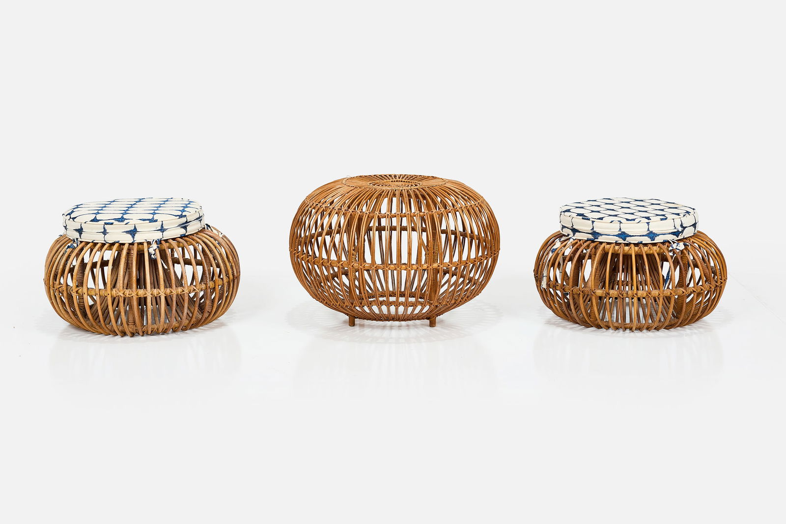 Franco Albini, Stools (3): FRANCO ALBINI Group of three stools, 1960s Rattan. Produced by Bonacina, Italy. Large: 17" H x 24" Diameter Each small: 11" H x 20" Diameter