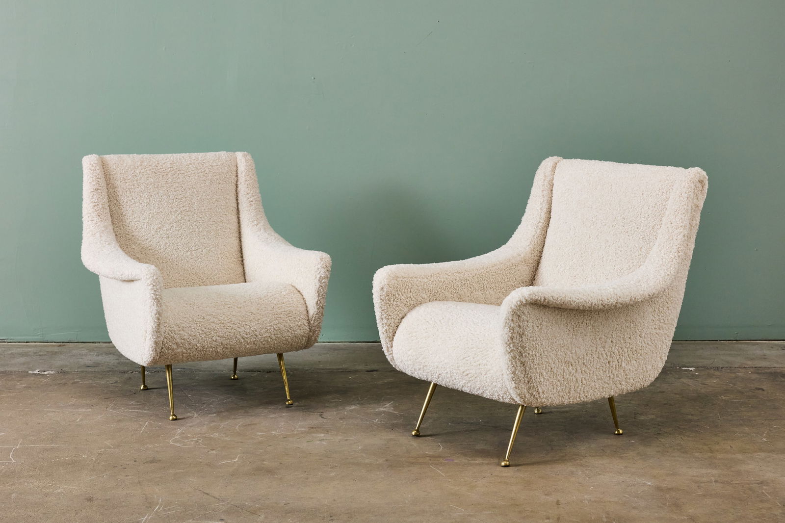 Gigi Radice, Lounge Chairs (2): GIGI RADICE Pair of lounge chairs, 1950s Faux shearling, brass. Produced in Italy. Each: 33.5" H x 30.5" W x 32" D Seat height: 17" 