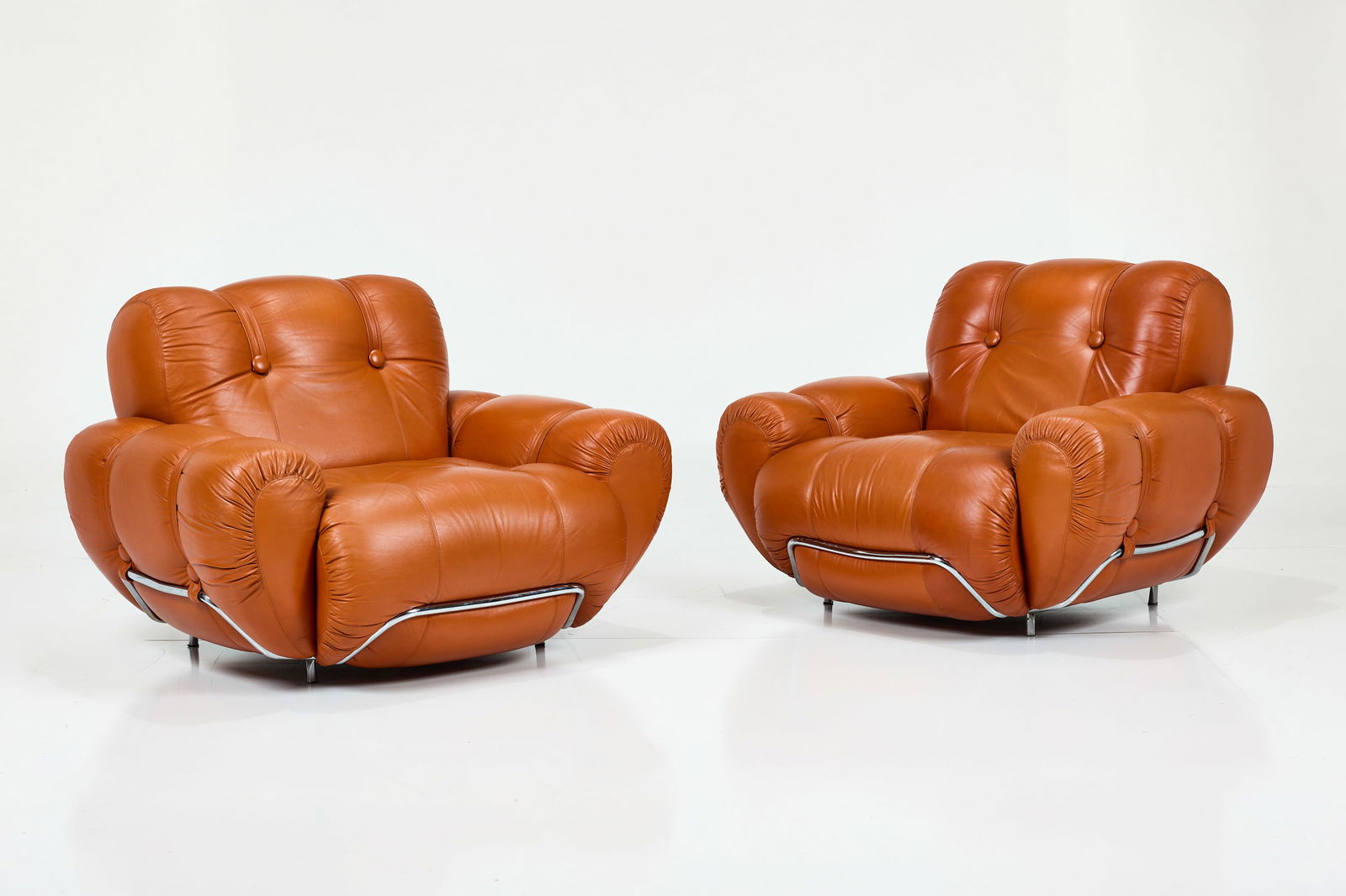 Italian, Lounge Chairs (2): ITALIAN Pair of lounge chairs, 1970s Leather, chrome-plated tubular steel. Each: 31" H x 42" W x 39" D Seat height: 15"