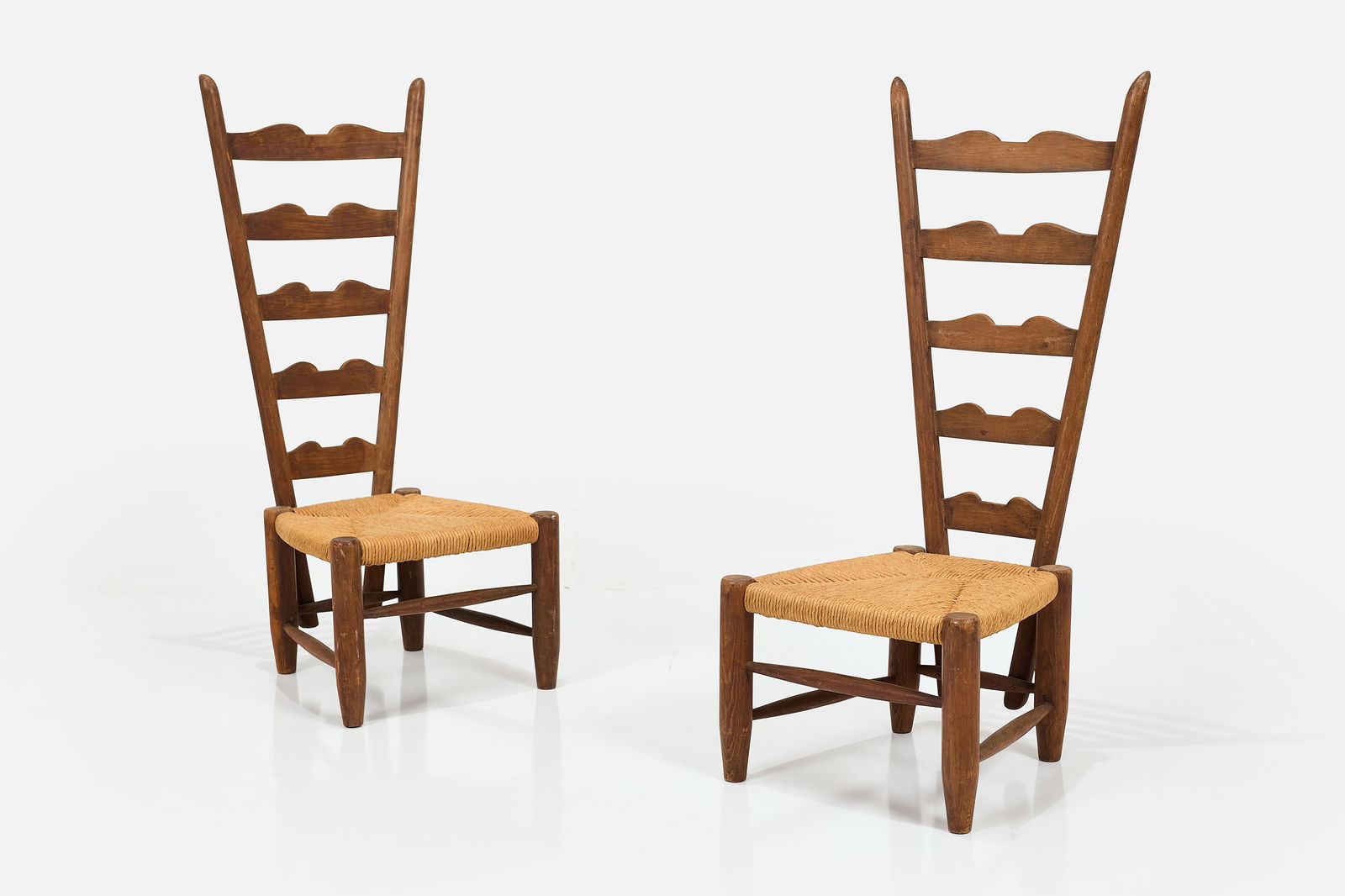 Gio Ponti, 'Fireside' Chairs (2): GIO PONTI Pair of low 'Fireside' chairs, ca. 1939 Walnut, rush. Manufactured by Casa & Giardino, Italy. Each: 40" H x 16.5" W x 17.5" D Seat height: 12"