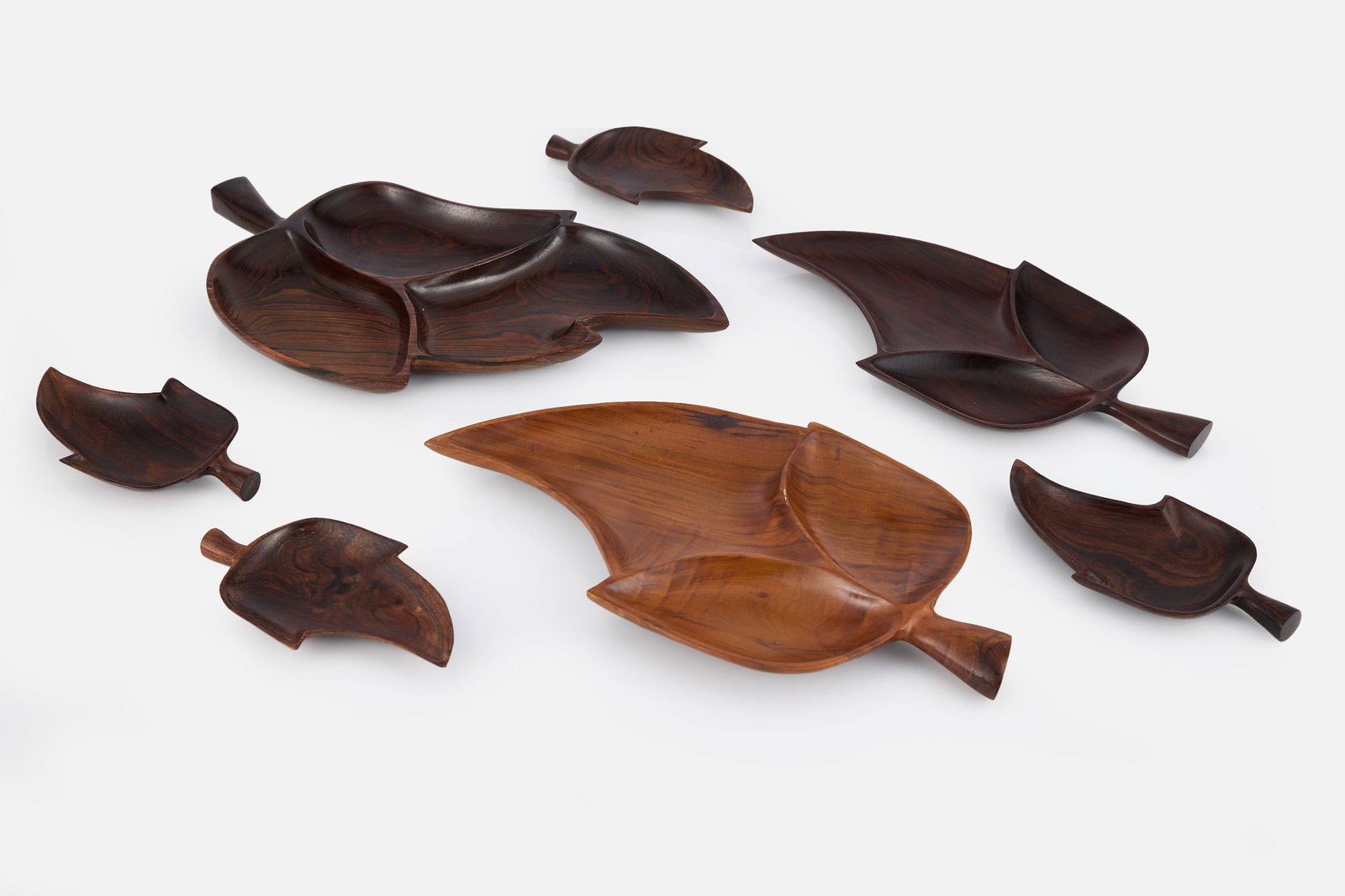 Brazilian, Leaf Dishes (7): BRAZILIAN Set of seven leaf plates, 1960s Jacaranda. Produced by Jac Art, Brazil. Two examples with producer's label. Large: 1" H x 17" W x 9" D Small: 0.75" H x