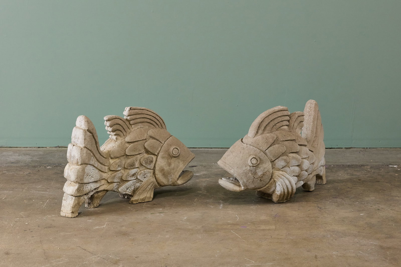 American, Fish Sculptures (2): AMERICAN Pair of fish sculptures, mid-20th century Cast cement. Each: 18" H x 28" W x 12" D 