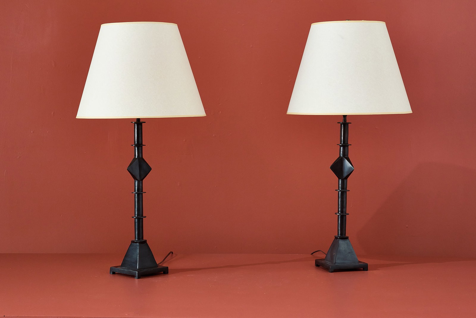 Tom Corbin Style, Table Lamps (2): TOM CORBIN STYLE Pair of table lamps, 2010s Patinated bronze. Each: 37.5" H x 6" W x 6" D Shade diameter: 19" 