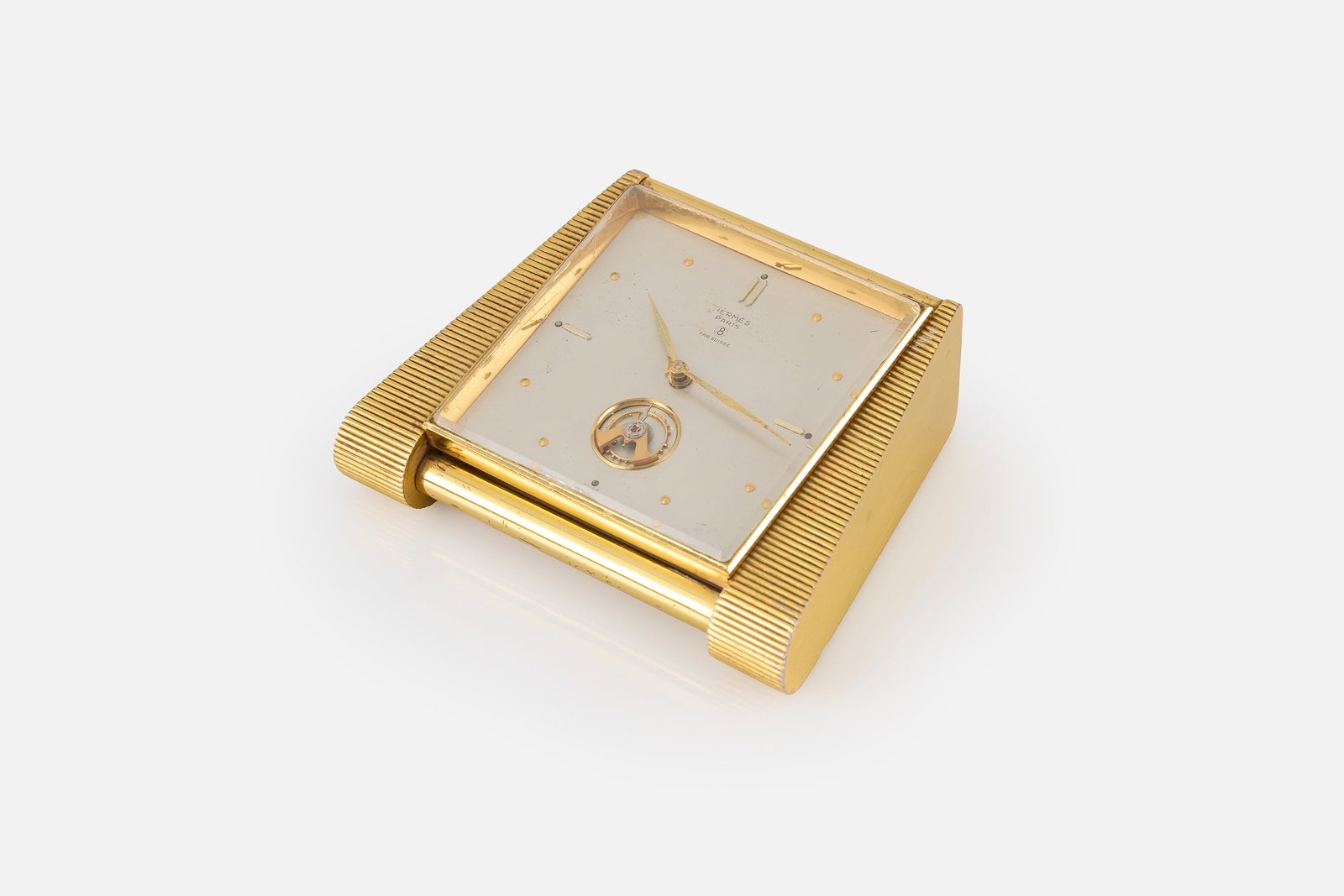 Hermes, Desk or Travel Clock: HERMES Desk or travel clock with alarm, 1950s Gilt brass, crystal. Produced in Switzerland for Hermes, France. Face with manufacturer's mark. 4" H x 4.5" W x 1" D