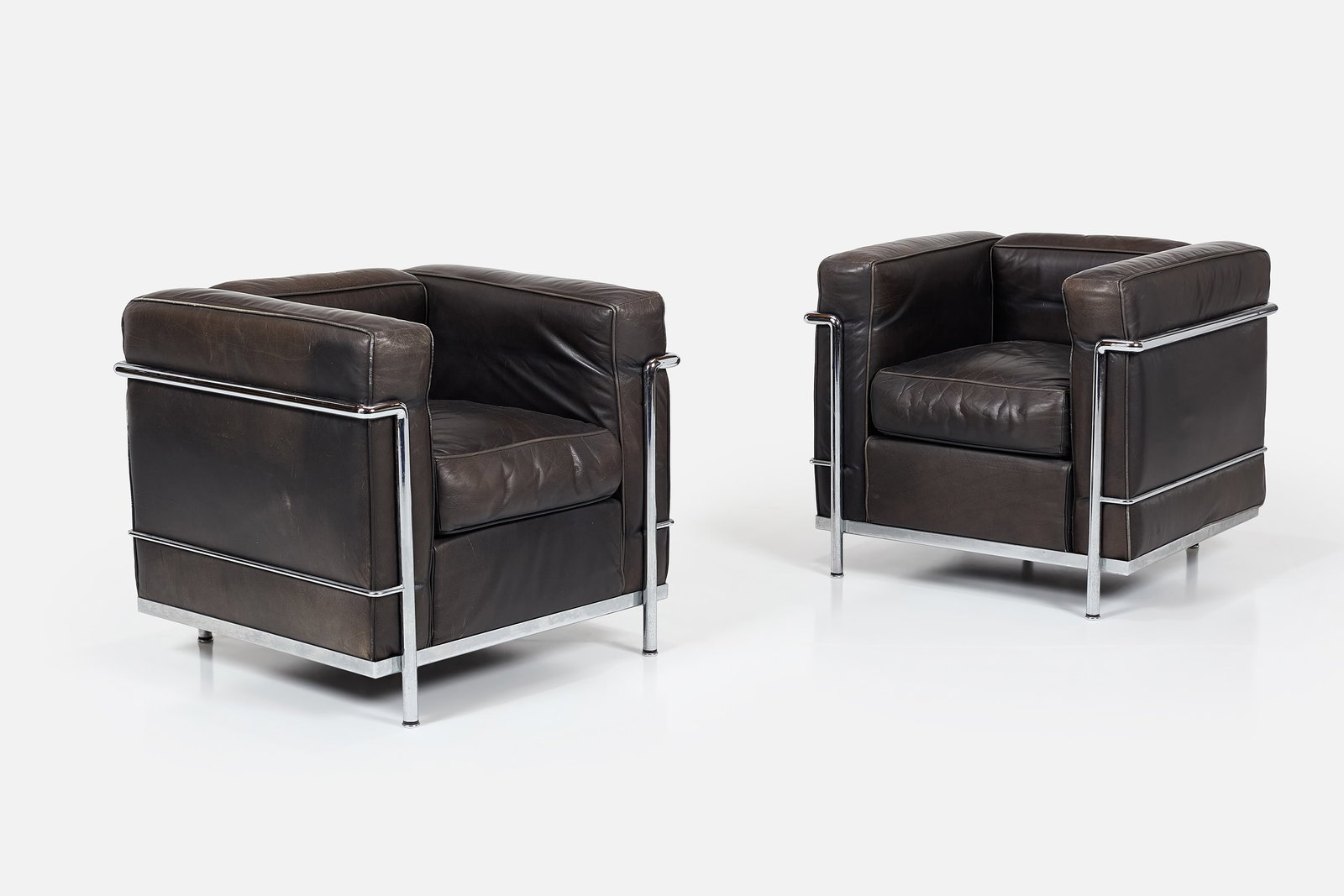Le Corbusier, Perriand + Jeanneret, 'LC2' Lounge Chairs (2): LE CORBUSIER, CHARLOTTE PERRIAND + PIERRE JEANNERET Pair of 'LC2' club chairs, 1928 / 1990s Chrome-plated metal, leather. Manufactured by Cassina, Italy. Underside with manufacturer's