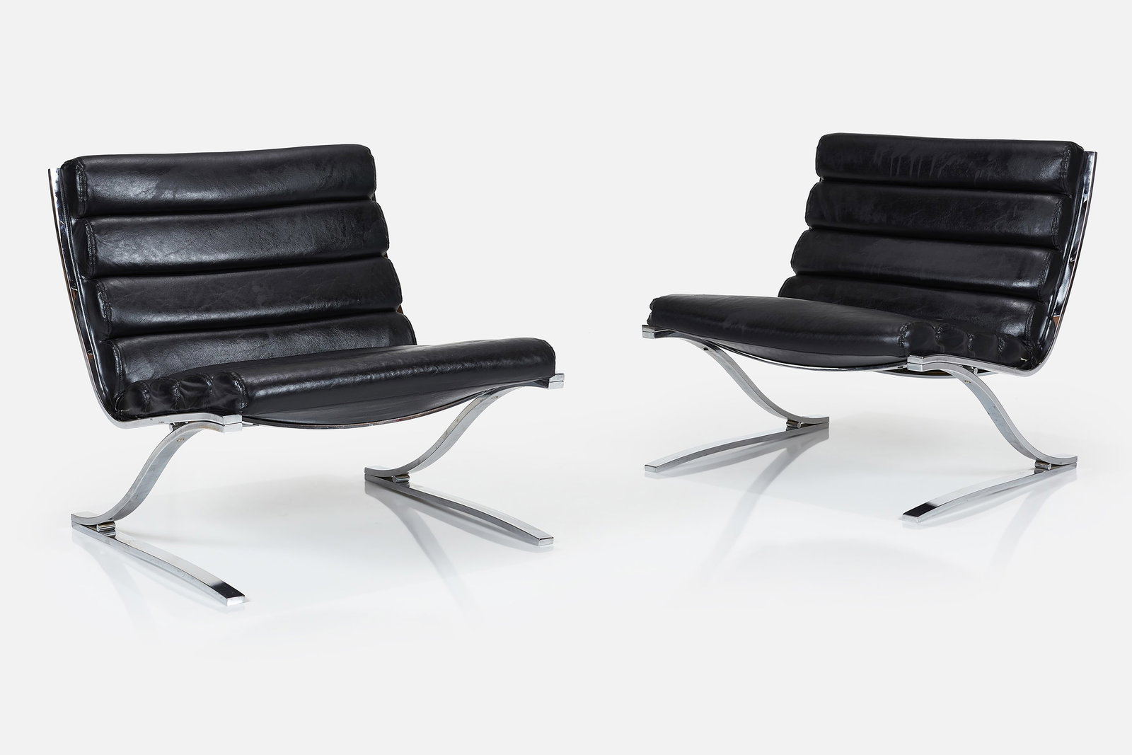 DIA, Lounge Chairs (2): DESIGN INSTITUTE OF AMERICA Pair of lounge chairs, 1970s Vinyl, chrome-plated flat steel. Manufactured by Design Institute of America, USA. One example with manufacturer's label to