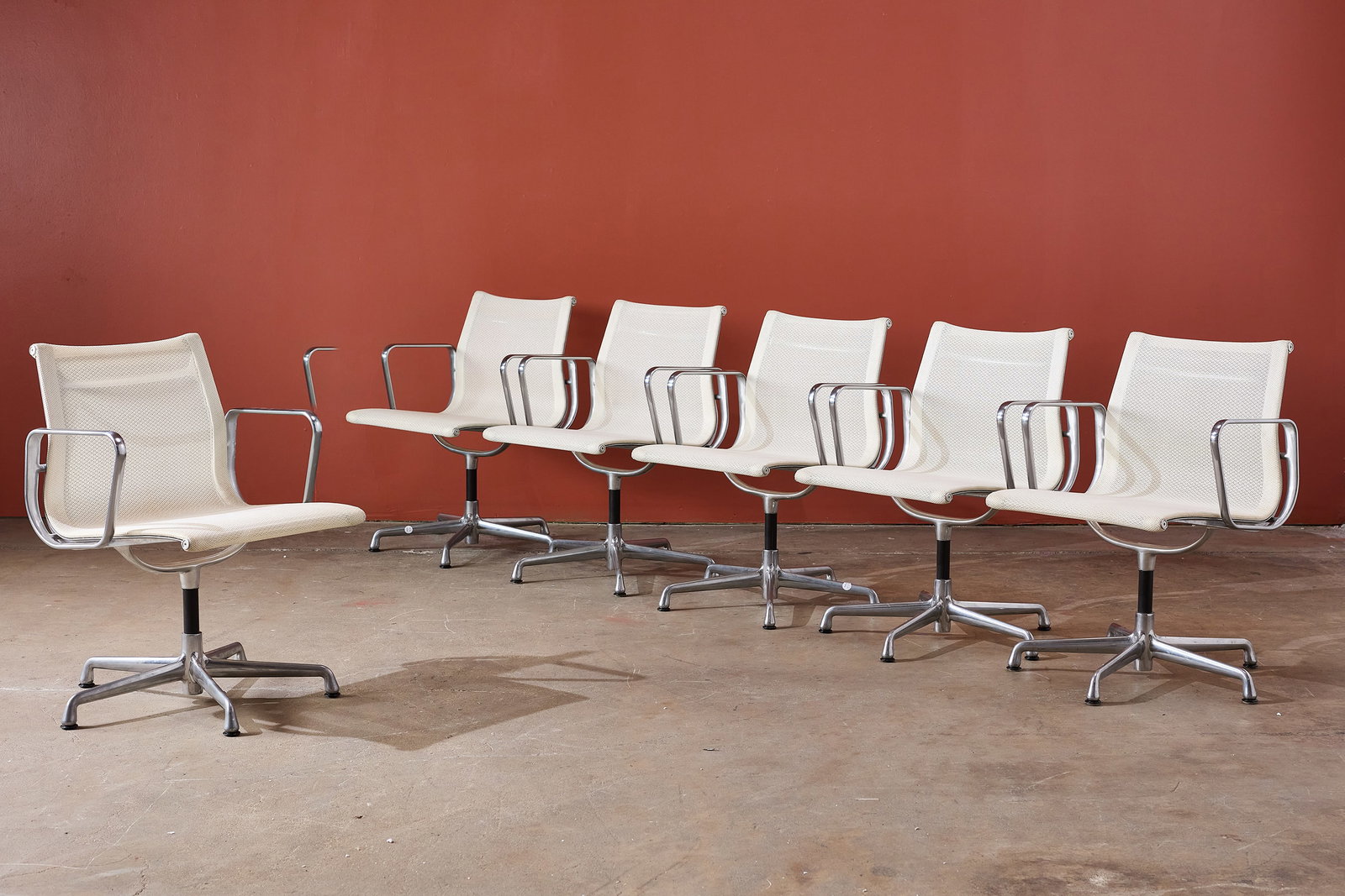 Charles + Ray Eames, 'Aluminum Group' Chairs (6): CHARLES + RAY EAMES Set of six 'Aluminum Group' chairs, 1980s Cast aluminum, leather. Manufactured by Herman Miller, USA. Underside with cast manufacturer's mark. Each: 33" H