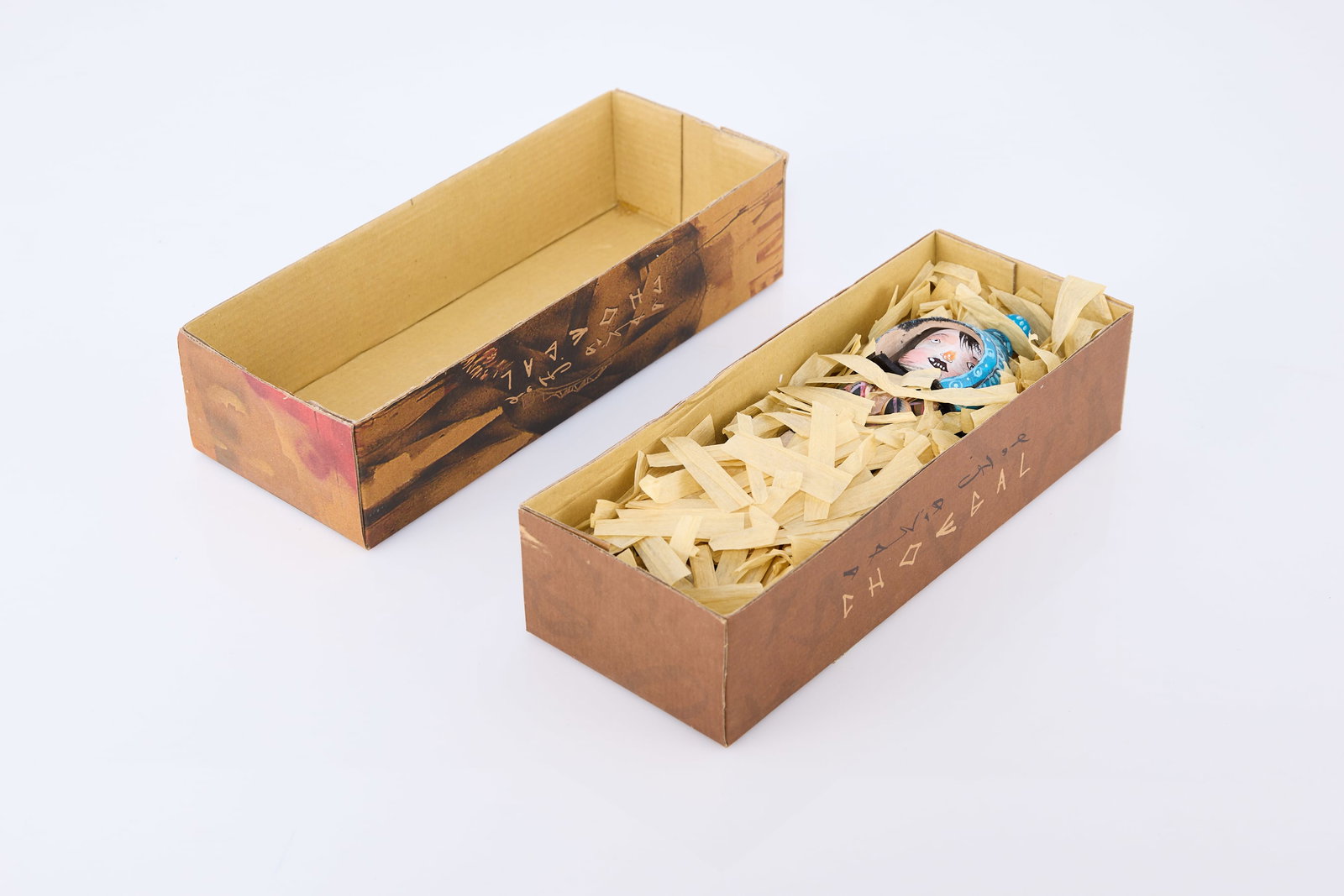 David Choe, 'Choegal' Figurine: DAVID CHOE 'Choegal', 2008 Hand-painted wooden figure in printed cardboard box. Stamped 'Nigyoushi 2008 © David Choe'. Box: 10" H x 4" W x 2.5" D 