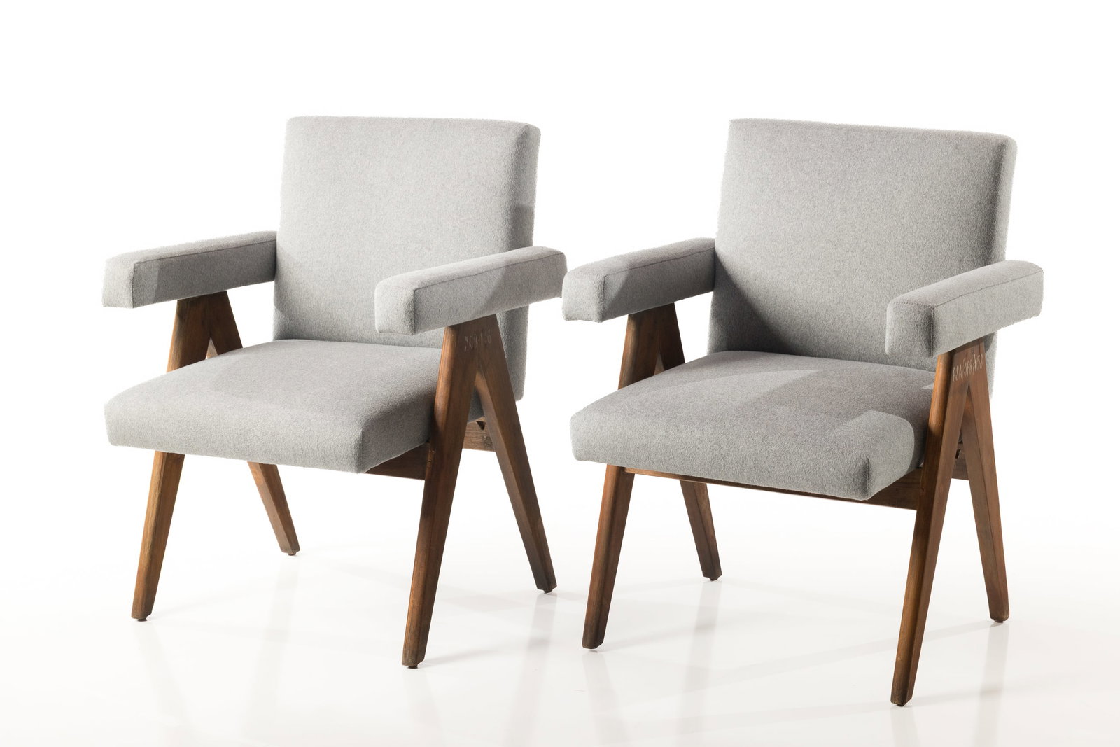 Pierre Jeanneret, 'High Court' Armchairs (2): PIERRE JEANNERET Pair of armchairs, ca. 1955 Teak, cane, fabric. Produced in France / India for the High Court, Chandigarh, India. Each with painted characters to the side. Each: