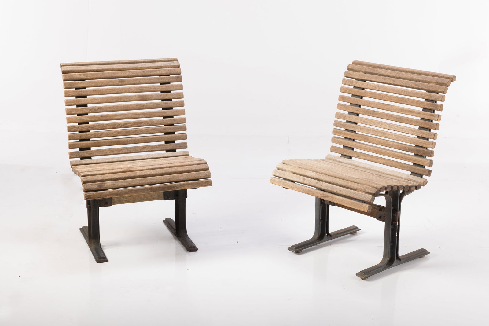 Falcon, Slatted Outdoor Chairs (2): FALCON Pair of outdoor chairs, 1950s Cast iron, oak. Manufactured by Falcon, USA. Fittings cast with manufacturer's mark. Each: 35.25" H x 24" W x 24" D