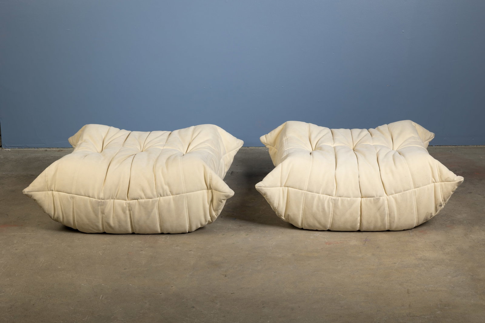 Michel Ducaroy, 'Togo' Ottomans (2): MICHEL DUCAROY Pair of 'Togo' ottomans, 2013 Alcantara, foam. Manufactured by Ligne Roset, France. Seam with fabric manufacturer's tag and underside with branded decking. 