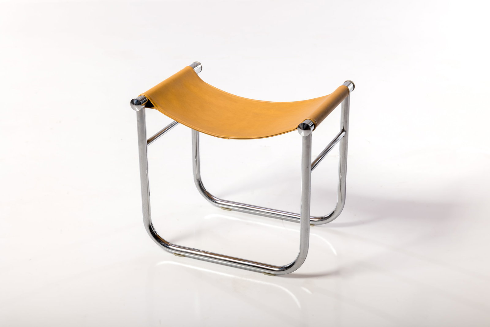 Perriand, Jeanneret + Le Corbusier, LC9 Stool: CHARLOTTE PERRIAND, PIERRE JEANNERET, + LE CORBUSIER Stool, model no. LC9, late 20th century Leather, chrome-plated steel. Manufactured by Cassina, Italy. Underside of frame with