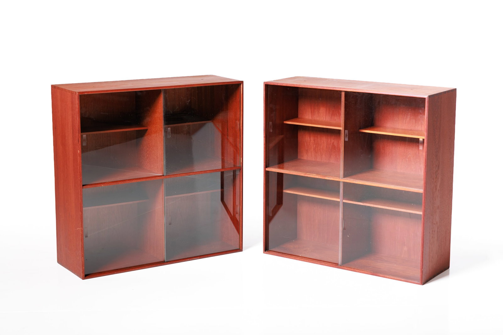 Peter Hvidt + Orla Molgaard Nielsen, Modular Bookcase (2): PETER HVIDT + ORLA MOLGAARD NIELSEN Two-piece modular bookcase, 1960s Teak, glass. Produced by Rud. Rasmussens, Denmark. Back of each with producer's paper label. Each cube/case: 28" H