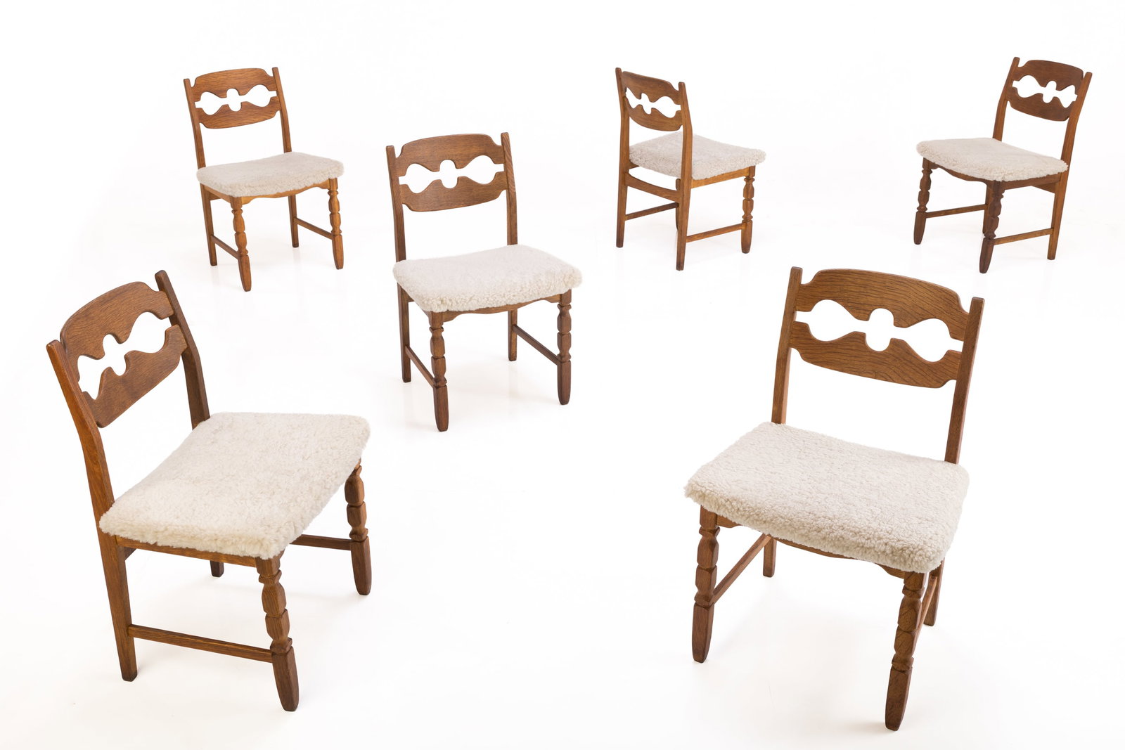 Henning Kjaernulf Style, 'Razor' Dining Chairs (6): HENNING KJAERNULF STYLE Set of six 'Razor' dining chairs, 21st century Oak, shearling. Produced in Denmark. Each: 33" H x 19.75" W x 18" D Seat height: 17.5"