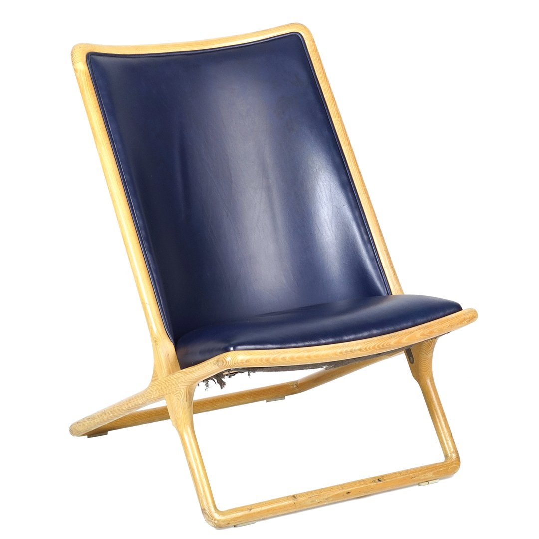Ward Bennett scissor chair: Oak framed Scissor chair upholstered in navy leather by Ward Bennett, 1960s.â€¨24â€ W x 29â€ D x 35â€ H.