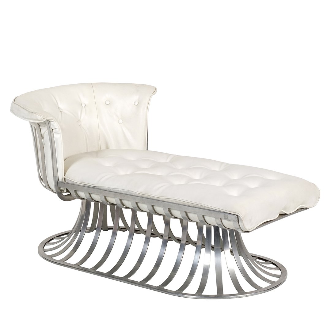 Russell Woodard chaise lounge: Spoke aluminum chaise lounge with white leatherette cushions by Russell Woodard, 1960s. 26" H x 54.5" W x 32" D.