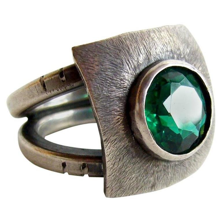 James Parker sterling silver and gemstone ring: Sterling silver ring with faceted synthetic emerald by James Parker, 1950s. Size 9 - 9.25 with a face that measures 7/8" square. Purchased from the estate of the artist, James Parker.