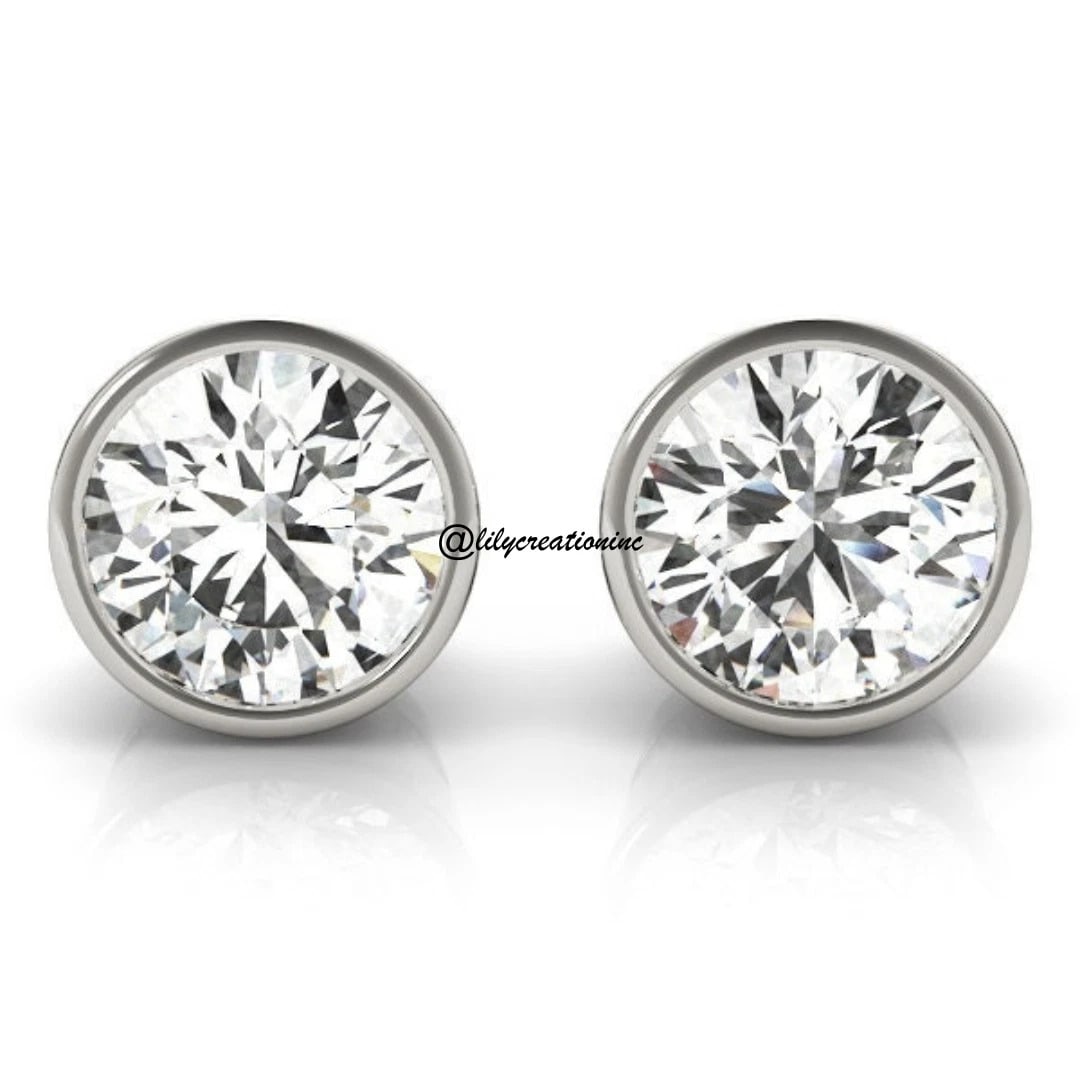 2 Carat Bezel Set Diamond Stud Earring in 14k White Gold: 14k White Gold Bezel Set Diamond Stud Earrings/Total Diamond Weight: 2 CaratSolid 14K White Gold and Conflict free Lab grown Diamonds/Diamond Quality: E In Color & VVS-VS In Clarity/Width : 9 mmBackin