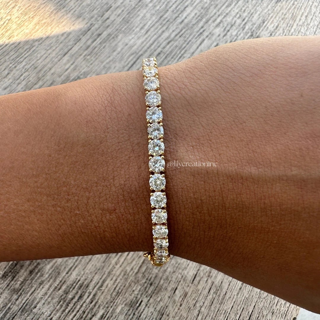 10 Carat Round Diamond Tennis Bracelet in 14k Yellow Gold: 14k Yellow Gold Round Diamond Tennis Bracelet/Length of the Bracelet: 7 Inches/Total Diamond Weight: 10 Carat in a 7 inch bracelet/Solid 14K Yellow Gold and Conflict free Lab grown Diamonds/Diamond Qu