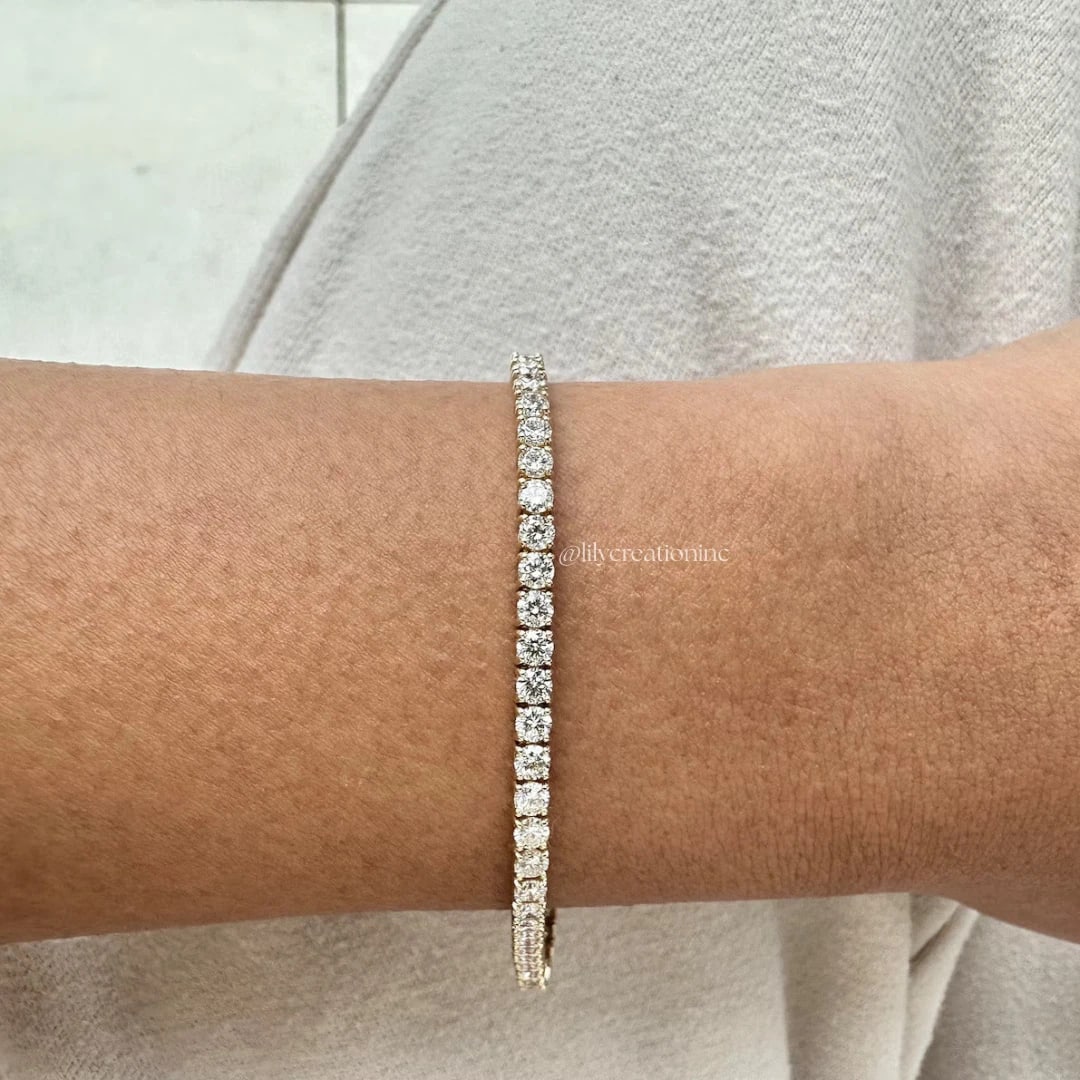 4 Carat Round Diamond Tennis Bracelets in 14k Yellow Gold: 14k Yellow Gold Round Diamond Tennis Bracelet/Length of the Bracelet: 7 Inches/Total Diamond Weight: 4 Carat in a 7 inch Bracelet/Solid 14K Yellow Gold and Conflict free Lab grown Diamonds/Diamond Qua